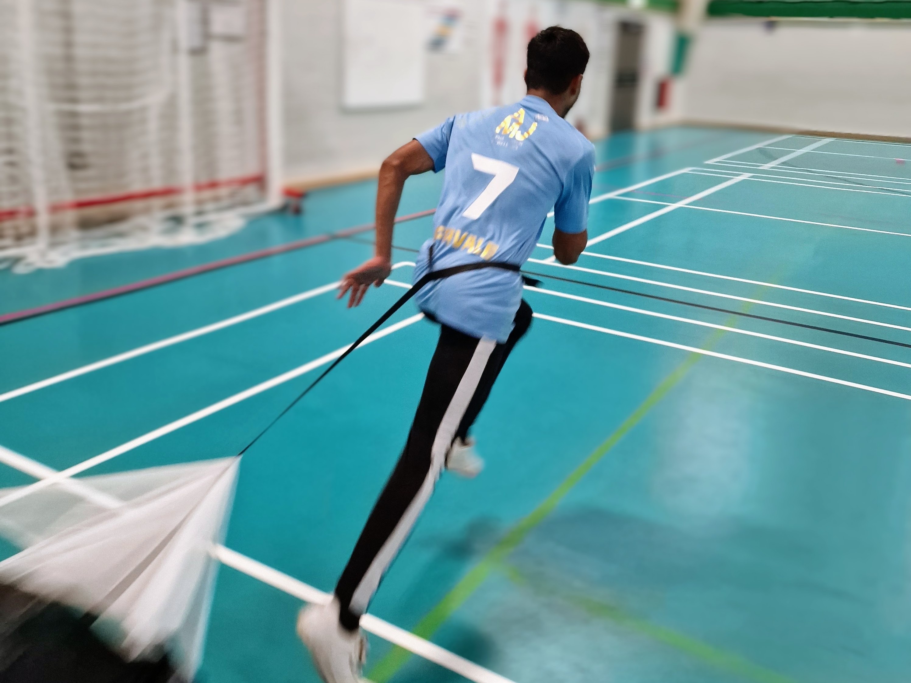 Teen sprints with a resistance parachute during fitness training at Astrea Academy, Sheffield.