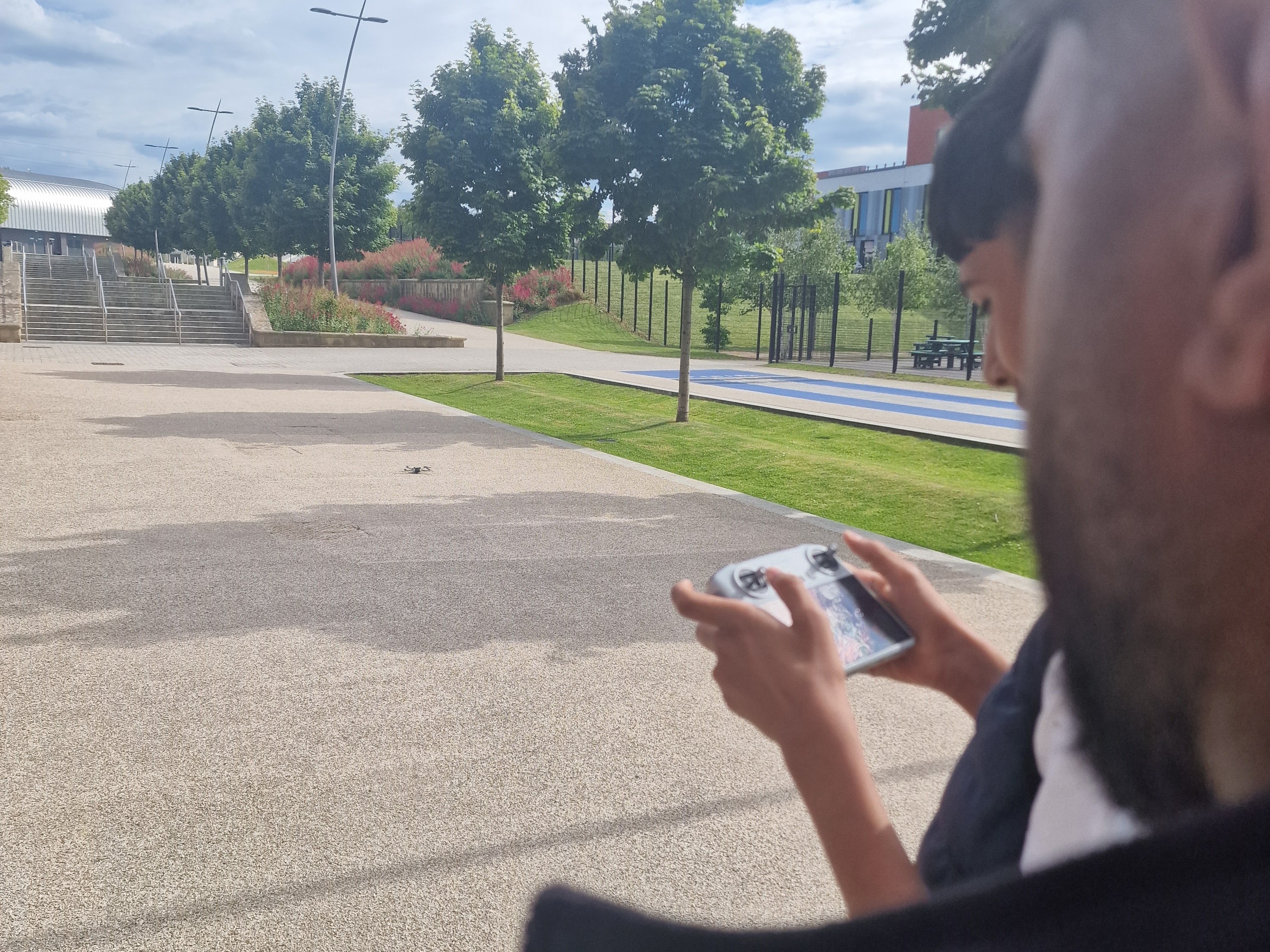Zayn practises supervised drone flight outside the office to capture media clips at Sheffield Olympic Legacy Park.