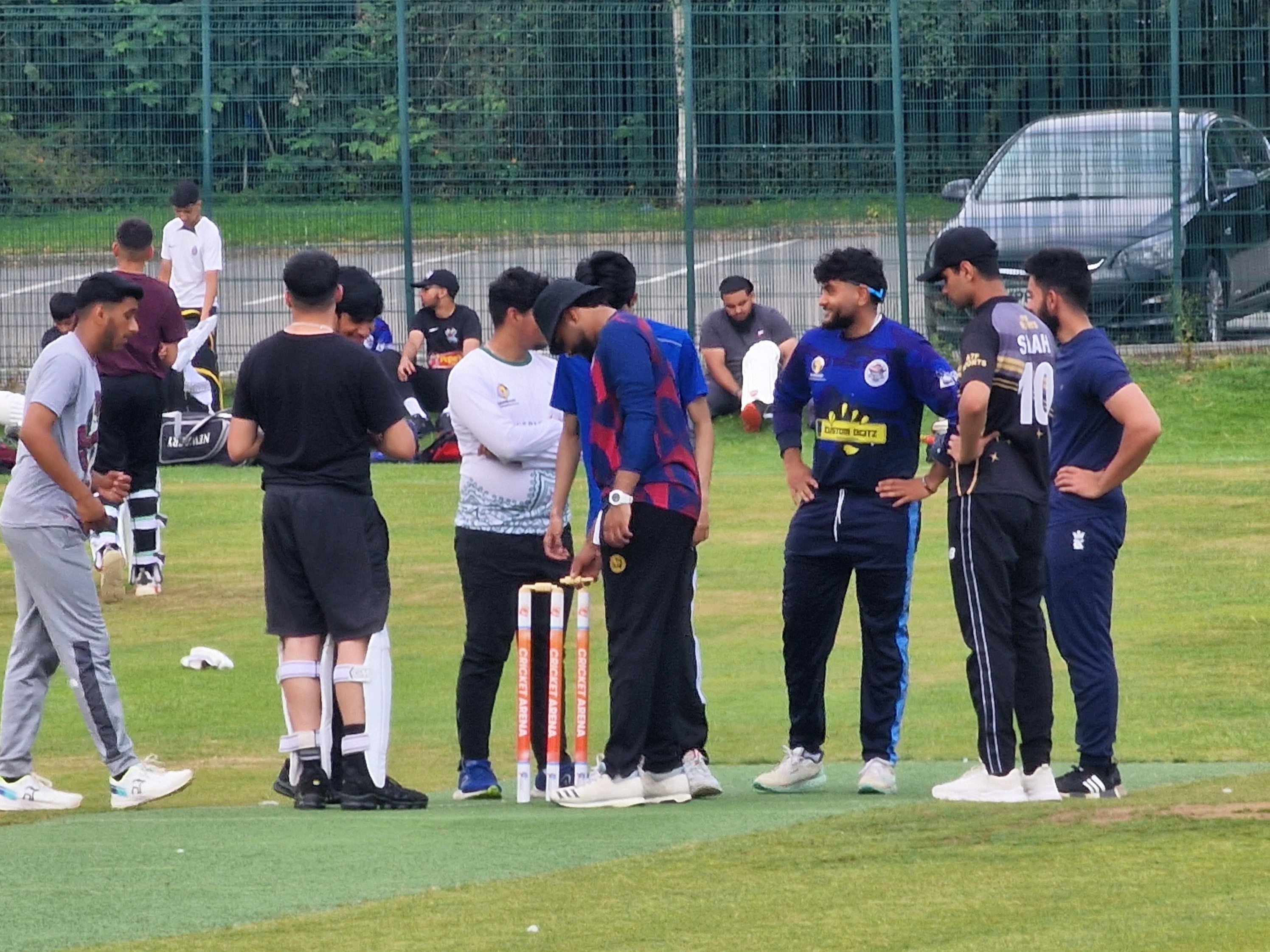 Netheredge players gather for a quick huddle, discussing tactics and teamwork after a wicket during Youth Hundred in Sheffield.