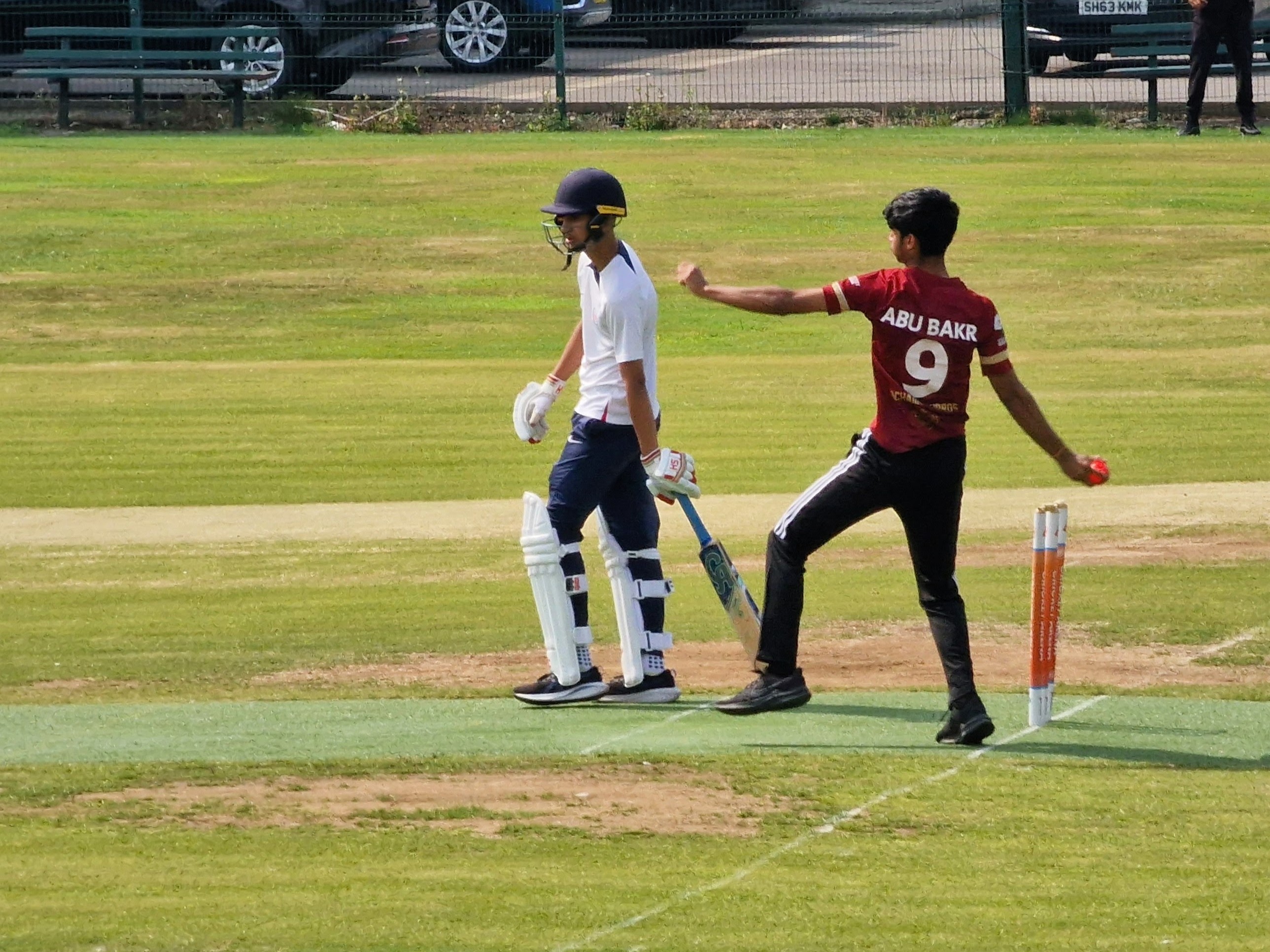 Bowler Abu Bakr runs in to deliver the pink hardball as batter prepares on the non-turf pitch during Youth Hundred in Sheffield.