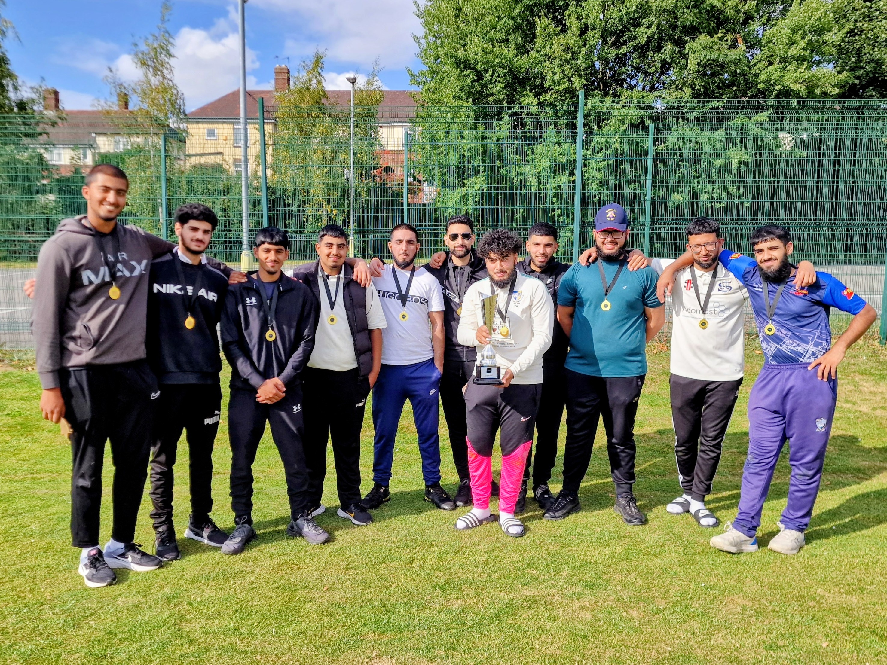 Winning team pose proudly with the Youth Hundred trophy and medals after Finals Day at Shiregreen Cricket Club, Sheffield.
