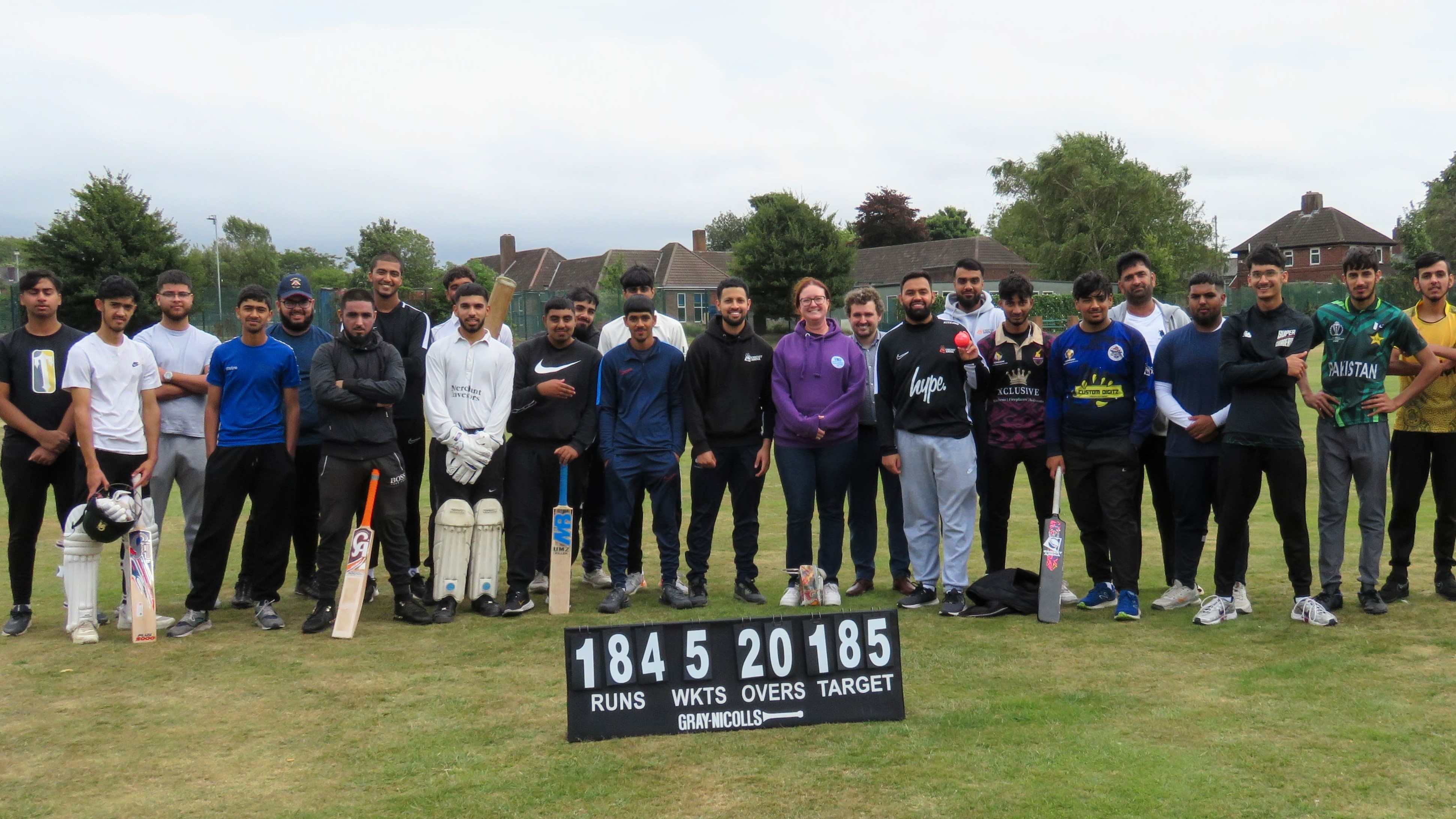 Cricket Arena Youth Sports Club players with South Yorkshire Violence Reduction Unit representatives at an outdoor hardball match at Shiregreen.
