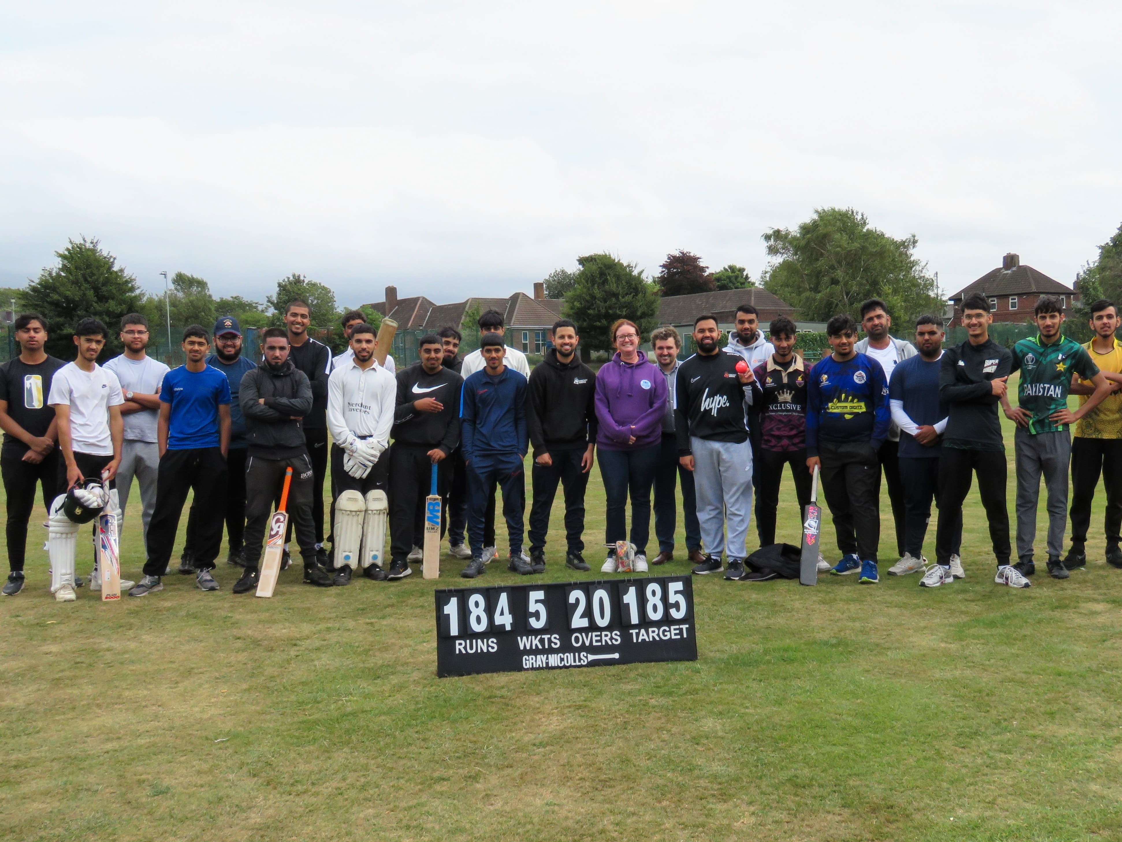 Cricket Arena Youth Sports Club players with South Yorkshire Violence Reduction Unit representatives at an outdoor hardball match at Shiregreen.