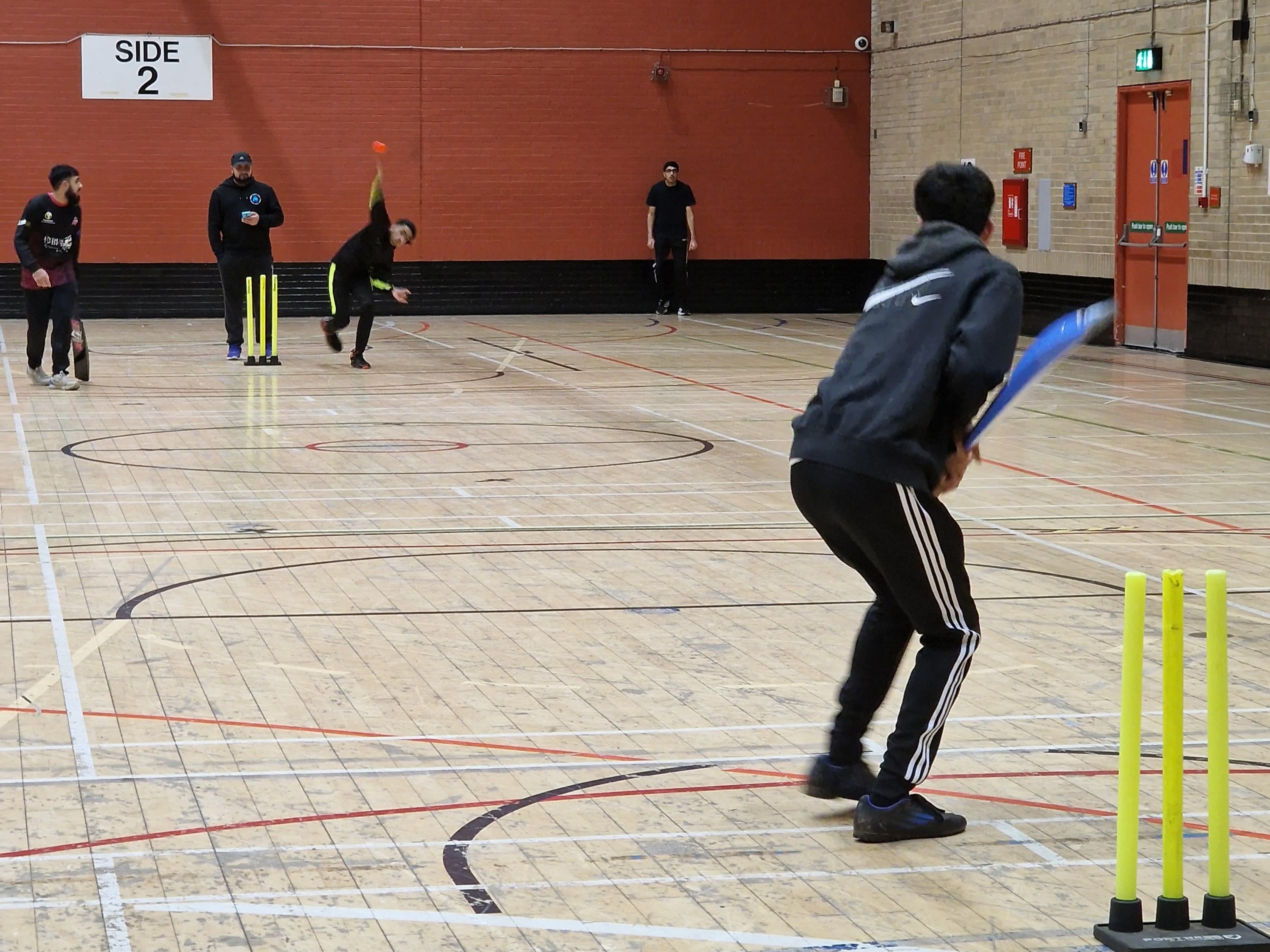 Bowler runs in to deliver a ball during a fast indoor windball cricket match at Concord Sports Centre in Sheffield.