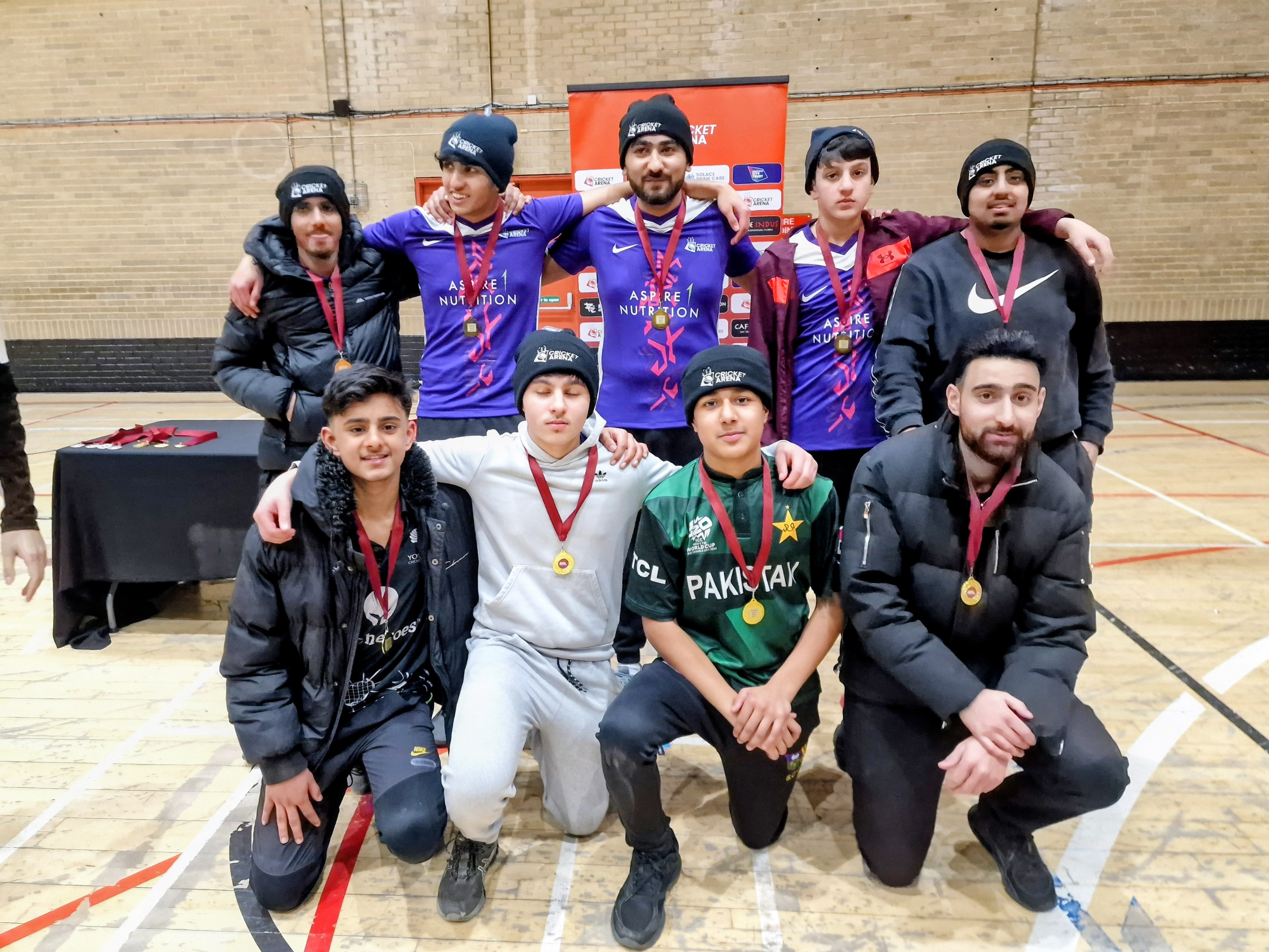 Pitsmoor Avengers under-21 champions huddle with medals and Cricket Arena beanies after winning the MBL 2024 indoor league at Concord Sports Centre in Sheffield.