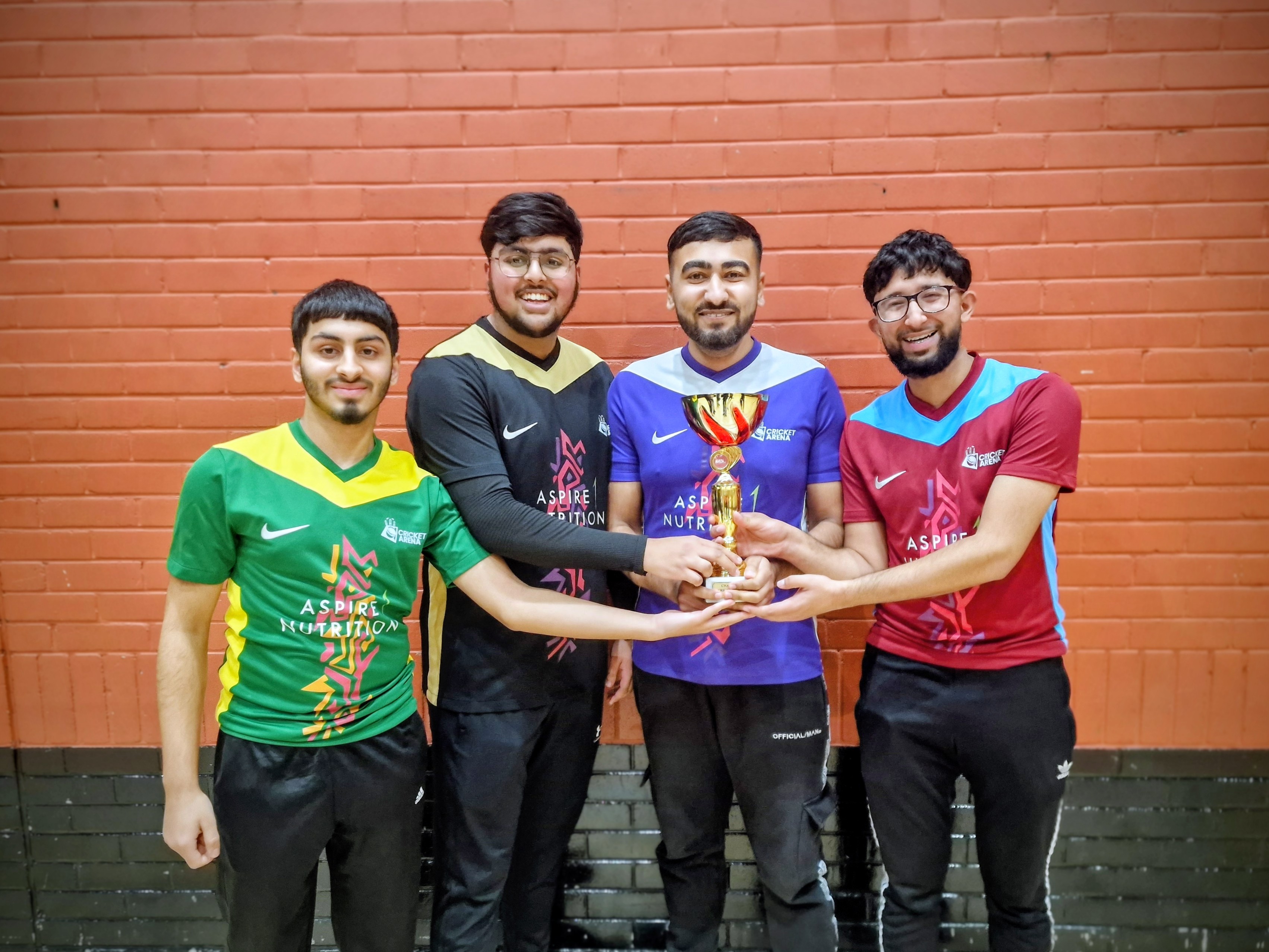 Four semi-final captains from Shiregreen Sharks, Sharrow Stars, Pitsmoor Avengers and Tinsley Thunder hold the MBL 2024 trophy together at Concord Sports Centre in Sheffield.