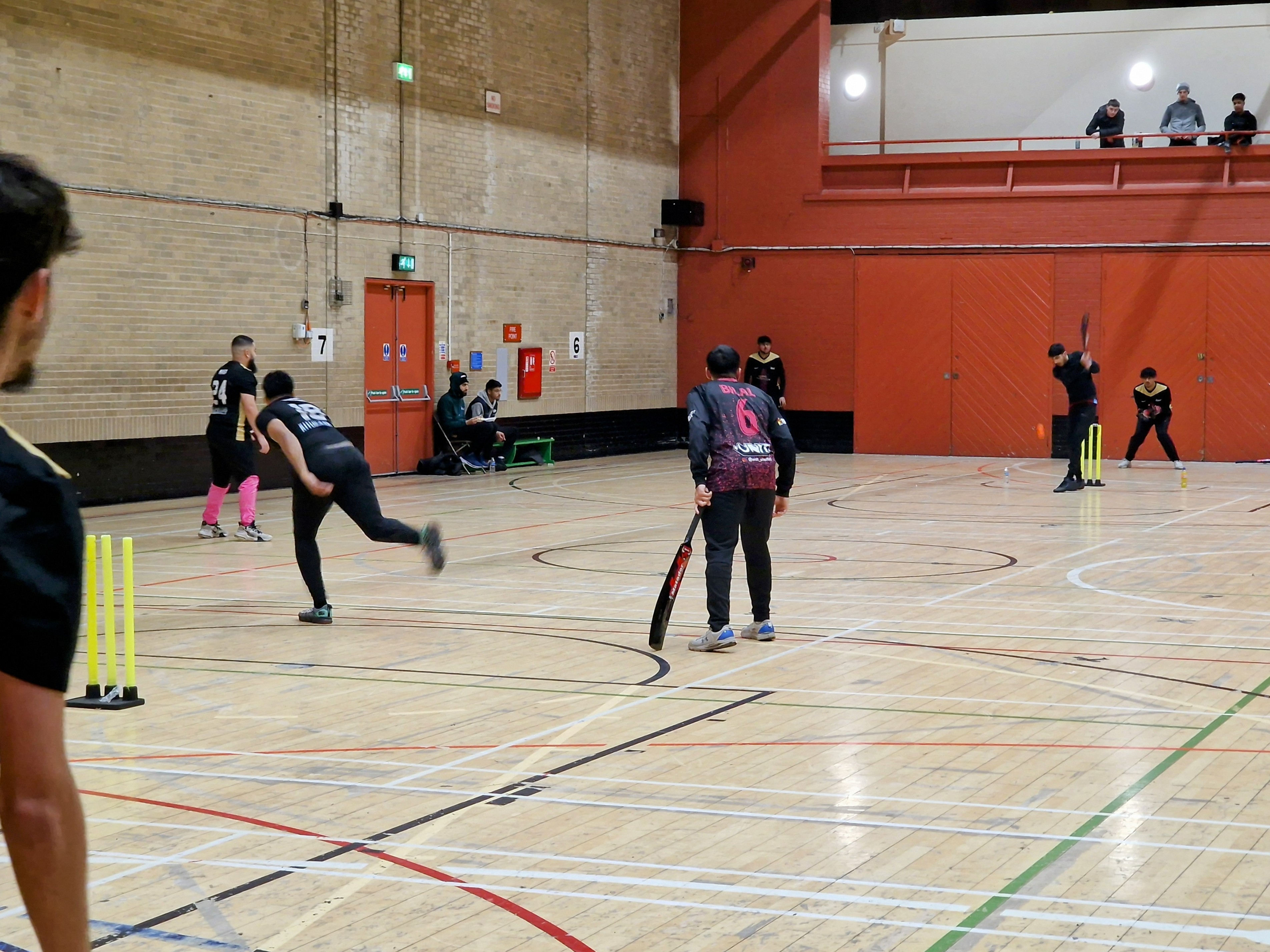 Young bowler runs in to deliver as the batter waits during MBL 2024 indoor cricket at Concord Sports Centre in Sheffield.
