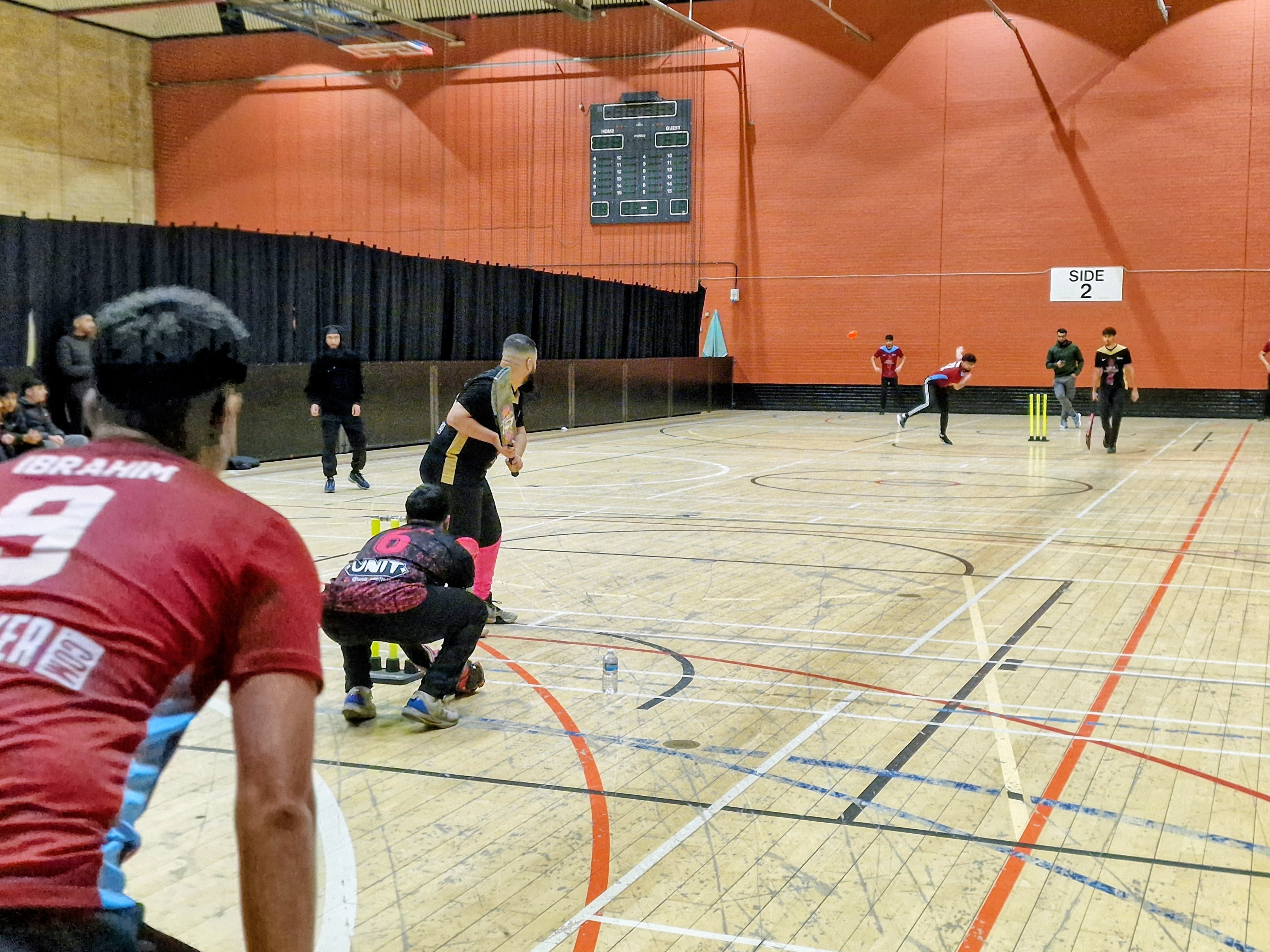 Indoor cricket match as Tinsley Thunder bowl to Sharrow Stars during MBL 2024 at Concord Sports Centre in Sheffield.
