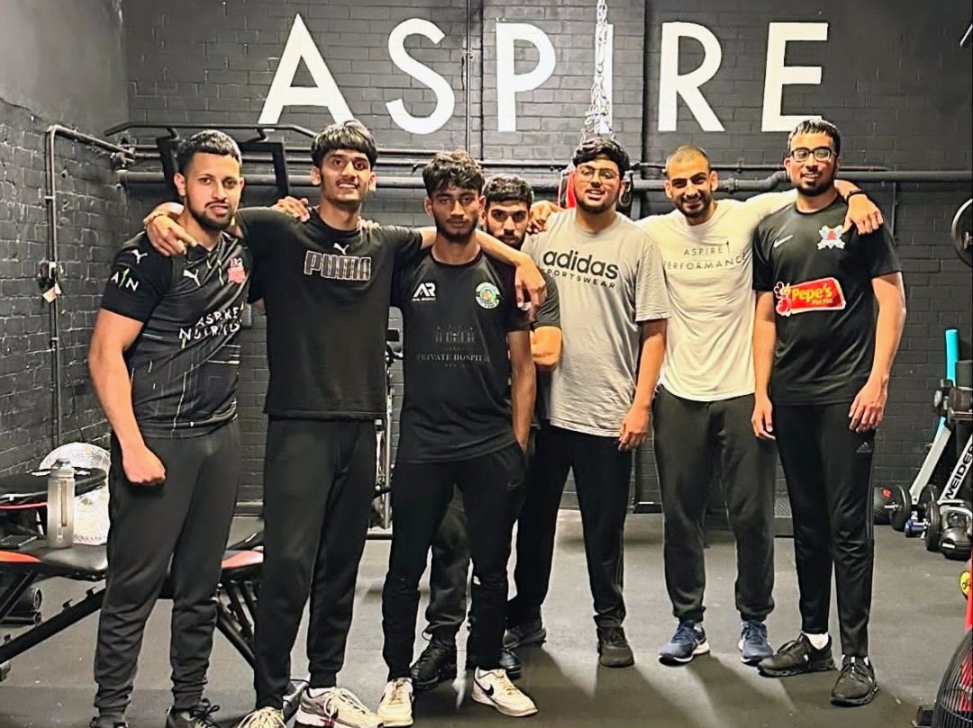 Young men stand arm in arm after a Cricket Arena fitness session at Aspire 1 gym in Sheffield, building strength, confidence and friendships.