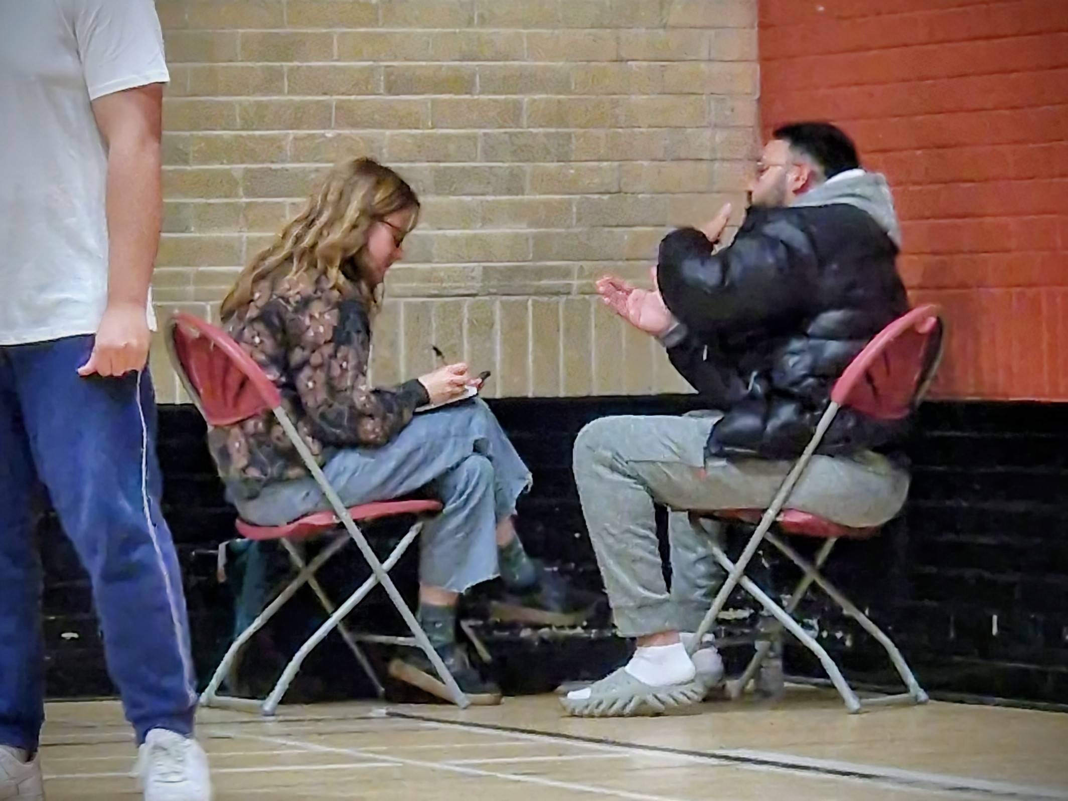 Evaluator Iona from Rocket Science interviews a coach at Concord Sports Centre, capturing learning and impact from Cricket Arena’s sessions.