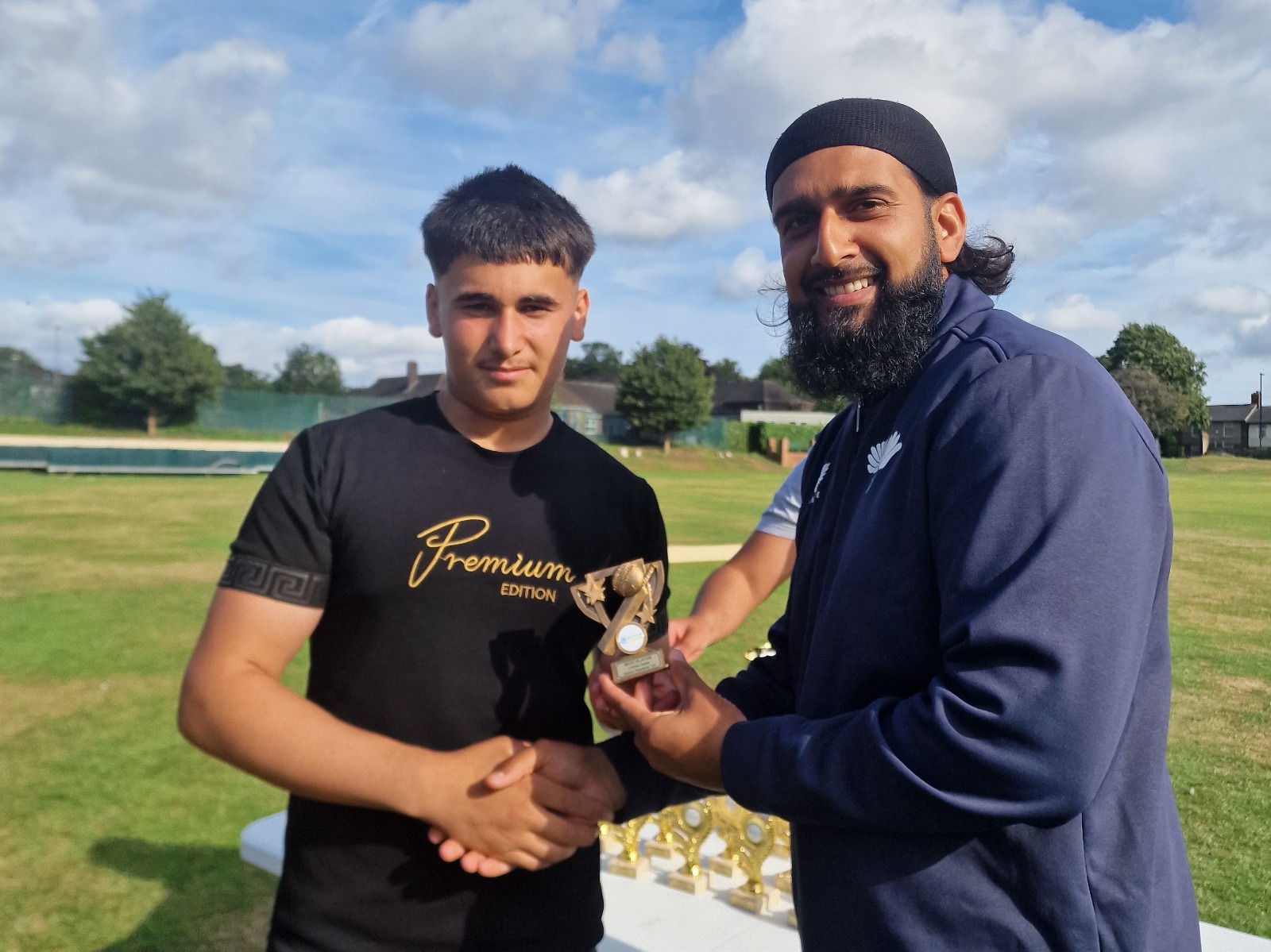 Yorkshire Cricket Foundation representative hands the MVP trophy to a Junior Hundred 2025 player during the presentation at Shiregreen Cricket Club.