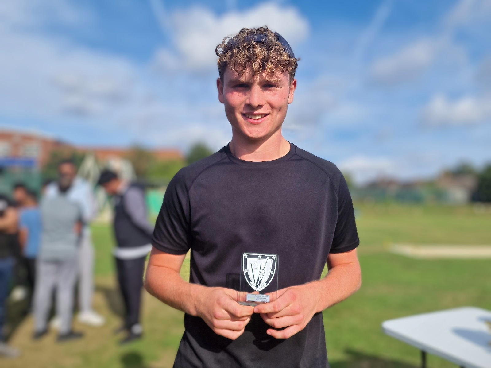 Junior Hundred 2025 Player of the Final holds his award and smiles after the presentation at Shiregreen Cricket Club in Sheffield.