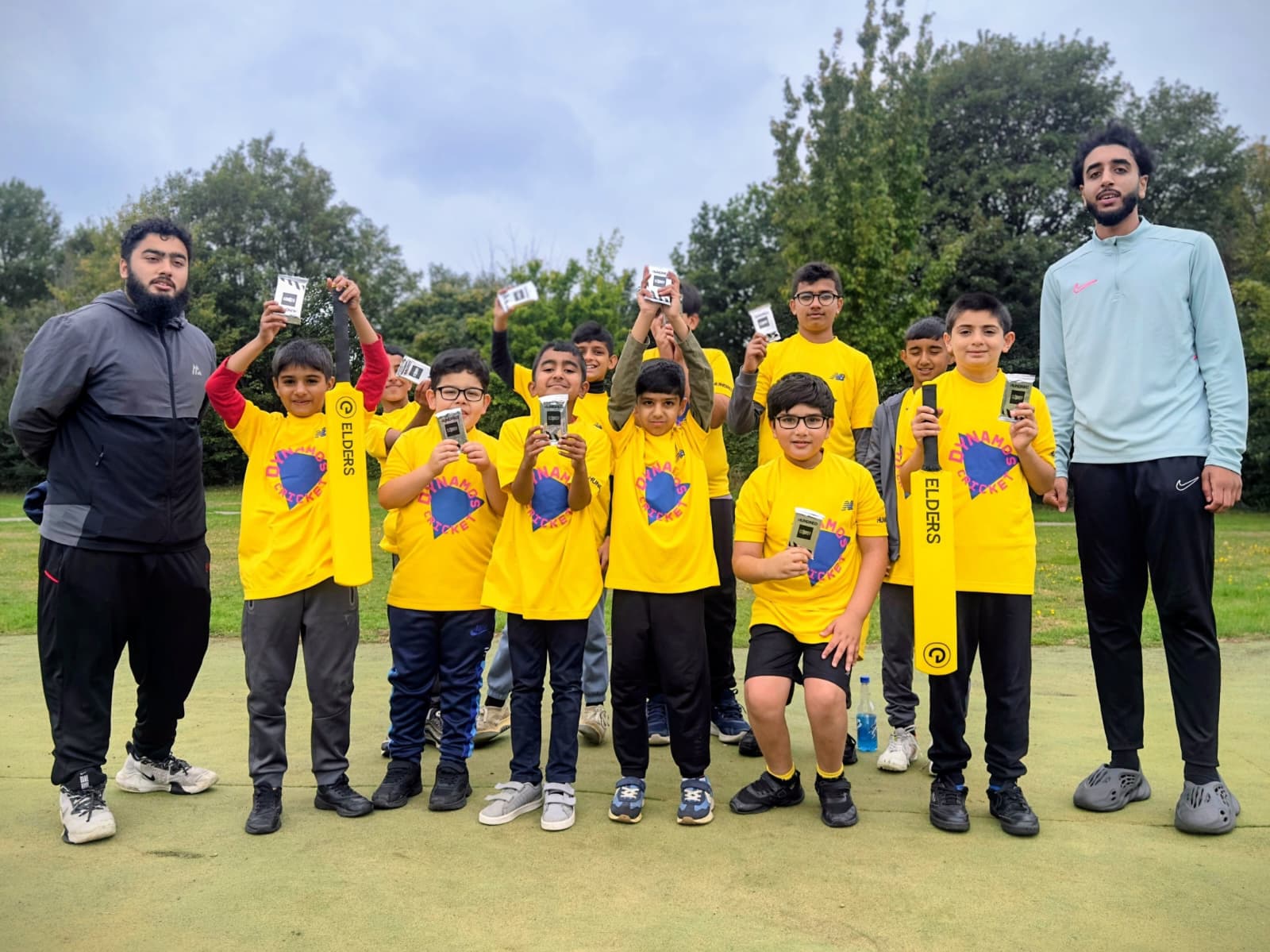 Boys celebrate completing Dynamos Cricket at Firth Park, Sheffield, with coaches, shirts and Cricket Attax cards.