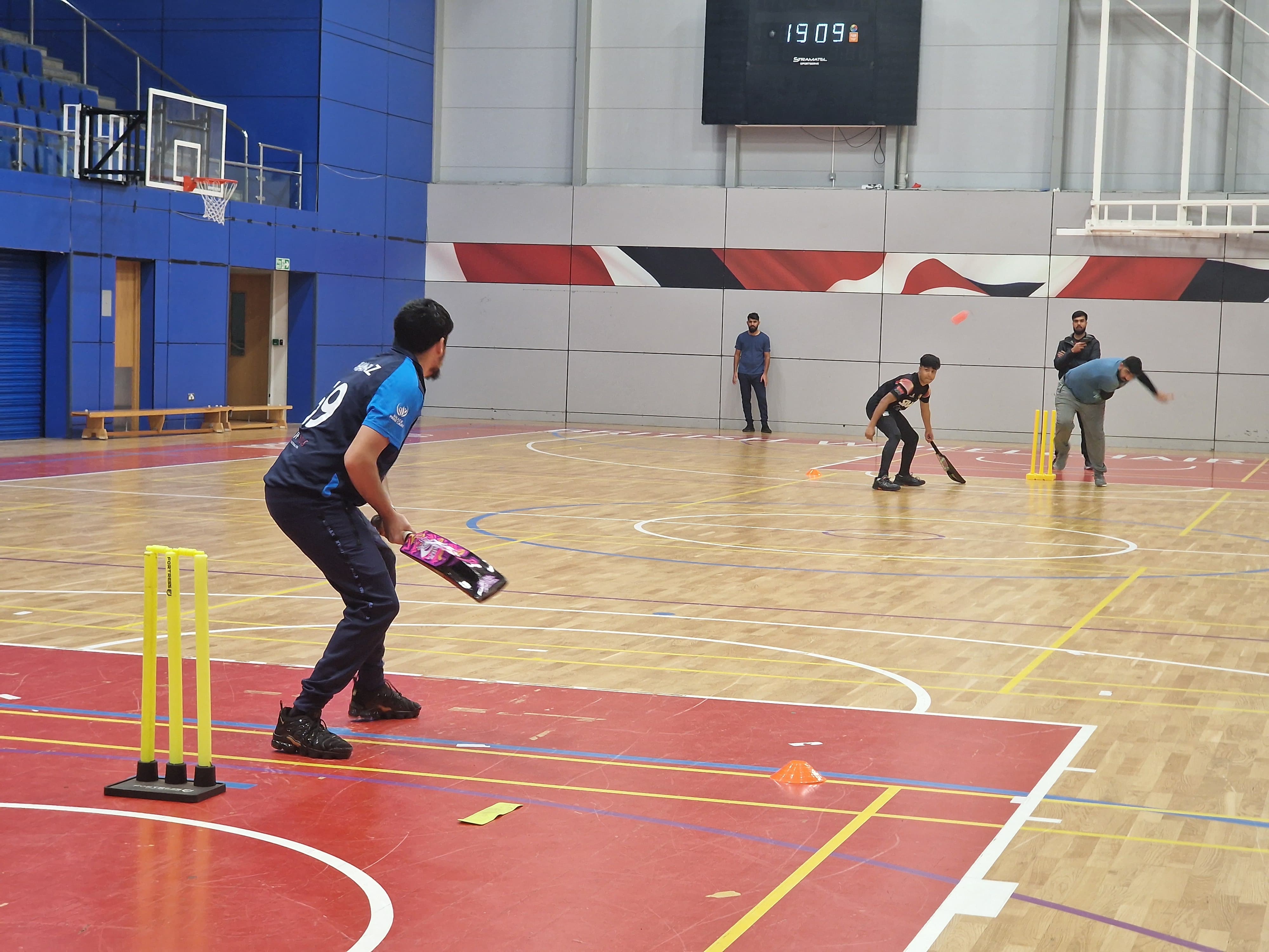 Shabaz bats during a BBICL match at EIS, Sheffield, playing indoor windball cricket with focus and control.