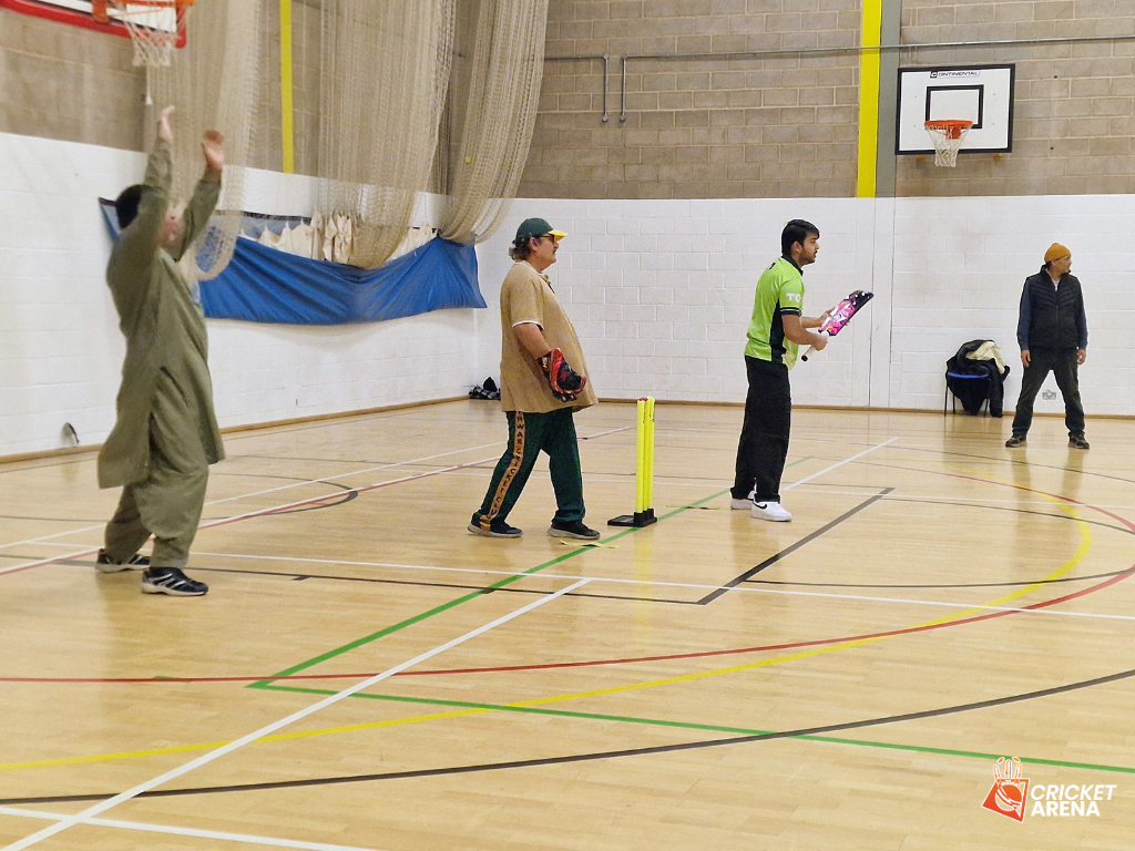 An umpire signals as a batter takes guard during a 50 Not Out walking cricket session at Firvale Sports Centre, Page Hall, Sheffield, bringing South Asian heritage and sport together.