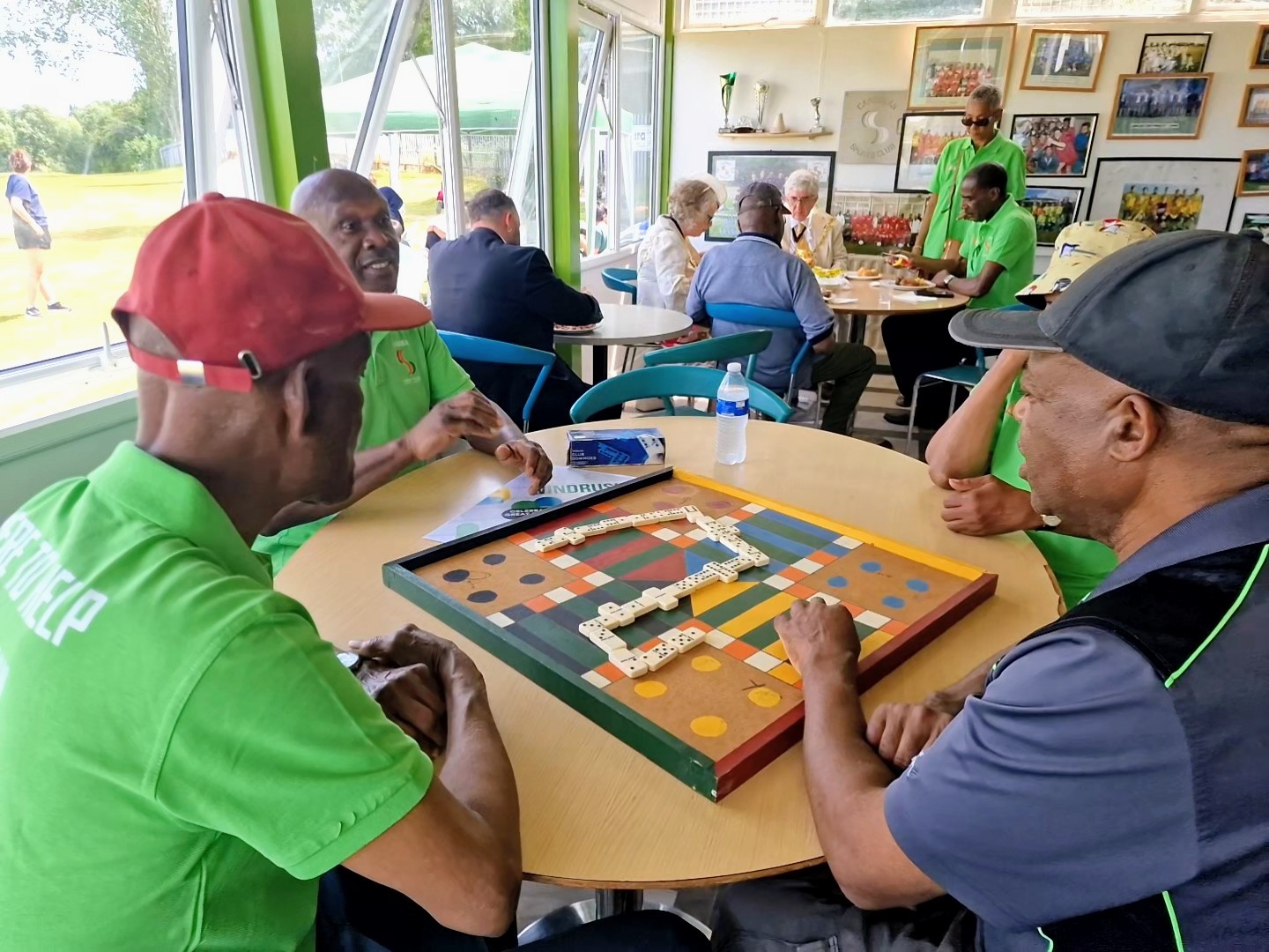 Elders play dominoes in the clubhouse as Windrush Day 2026 celebrations continue at Sheffield Caribbean Sports Club