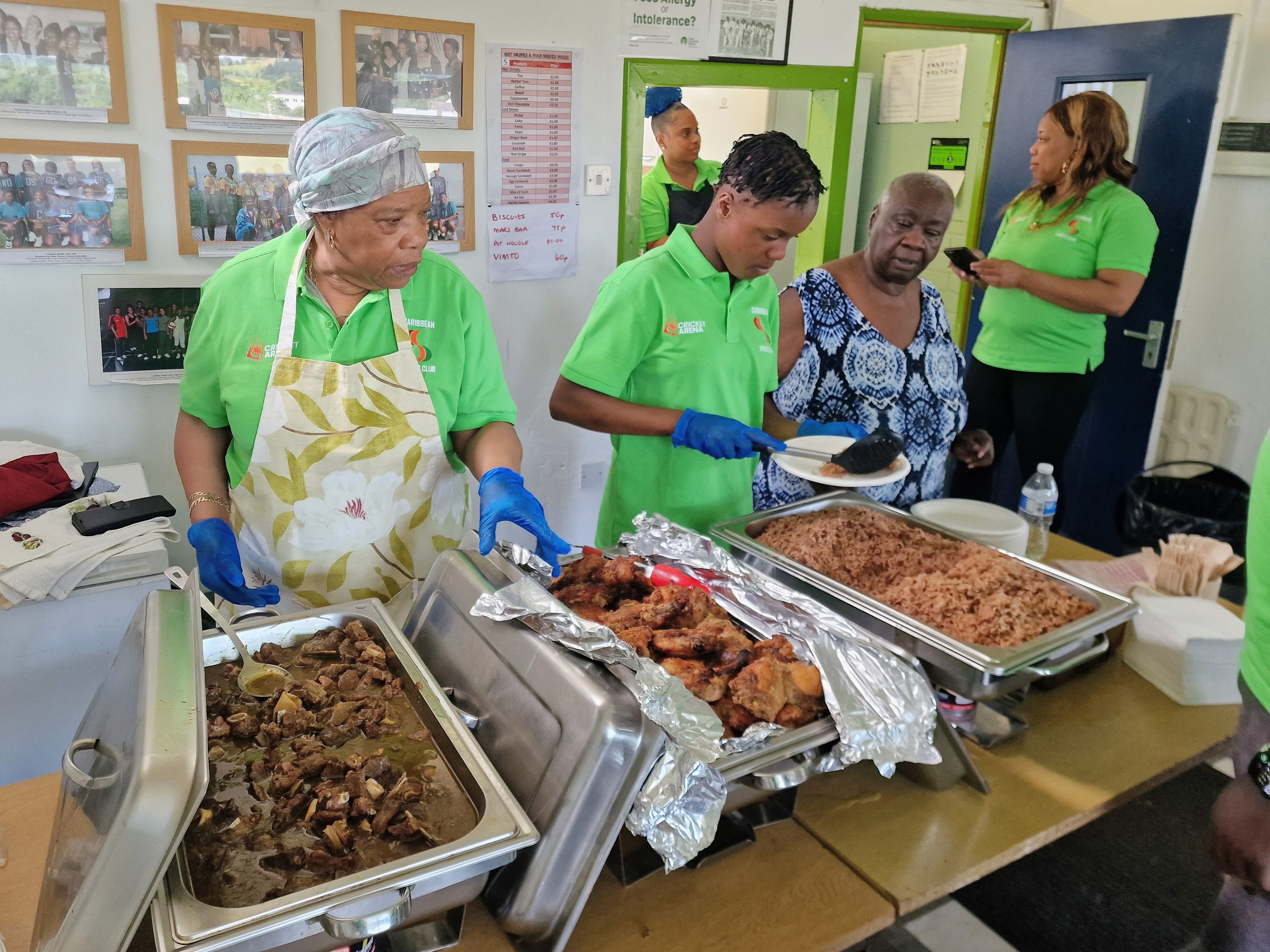 Volunteers serve homemade Caribbean food from the clubhouse kitchen, dishes drawn from across the Caribbean islands