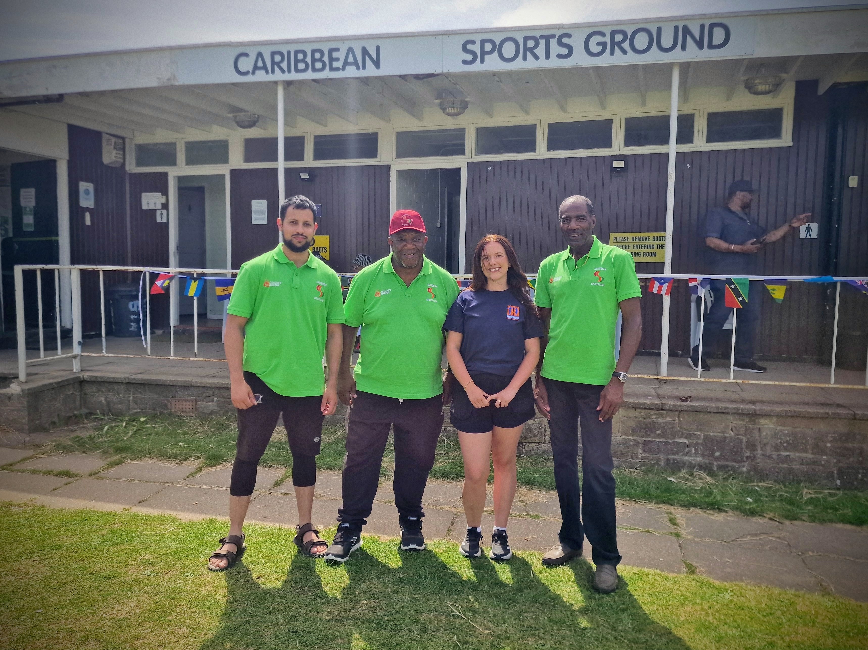 Sheffield Caribbean Sports Club volunteers gather under the clubhouse sign at the close of Windrush Day 2026