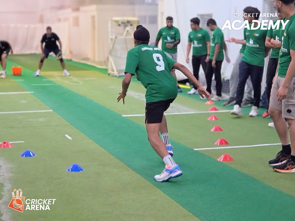 An Academy player drives forward in a fielding drill at the indoor centre in Sheffield, teammates watching on, building athleticism and sharpness.
