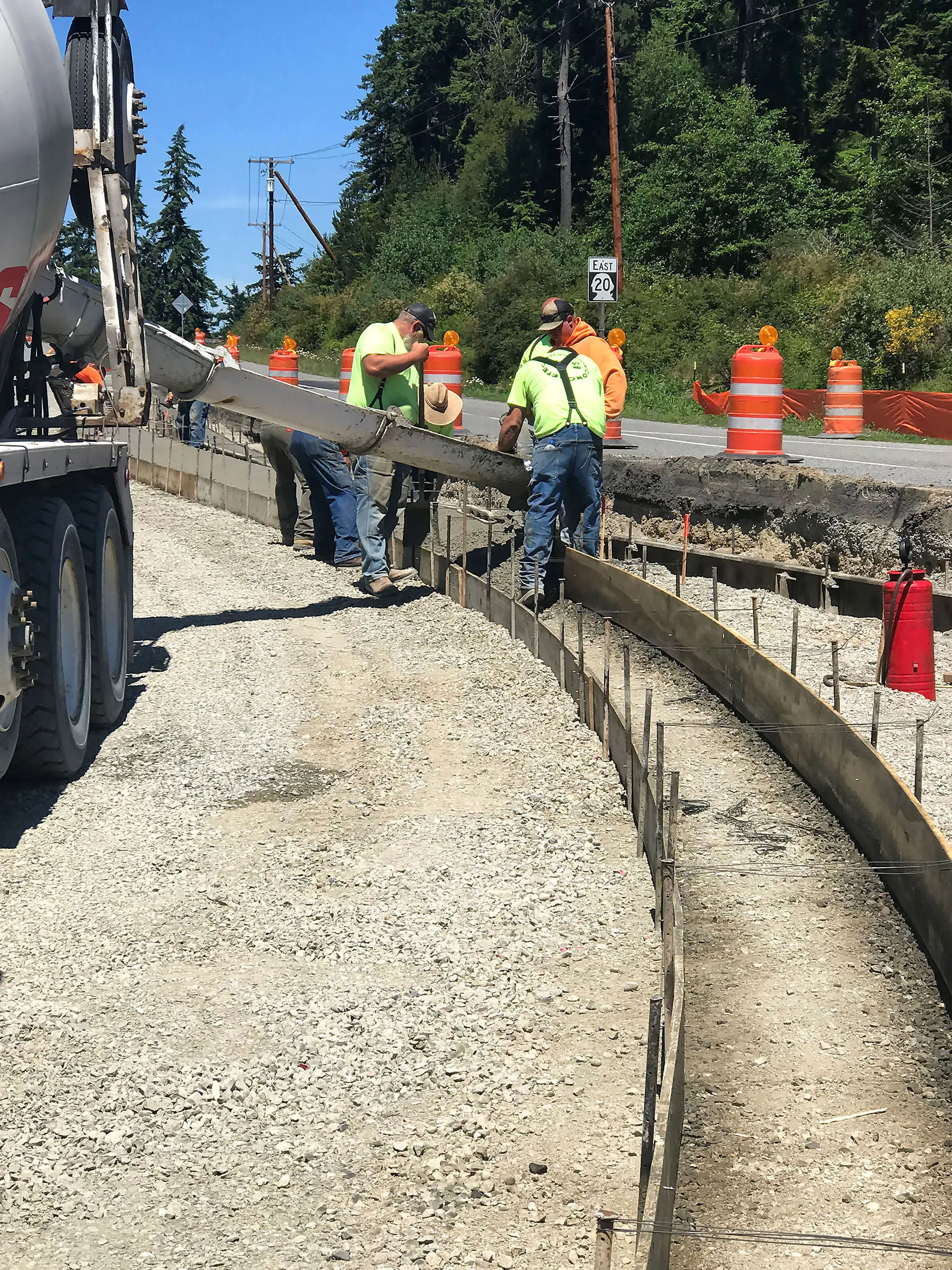 A group of construction workers working on a road.