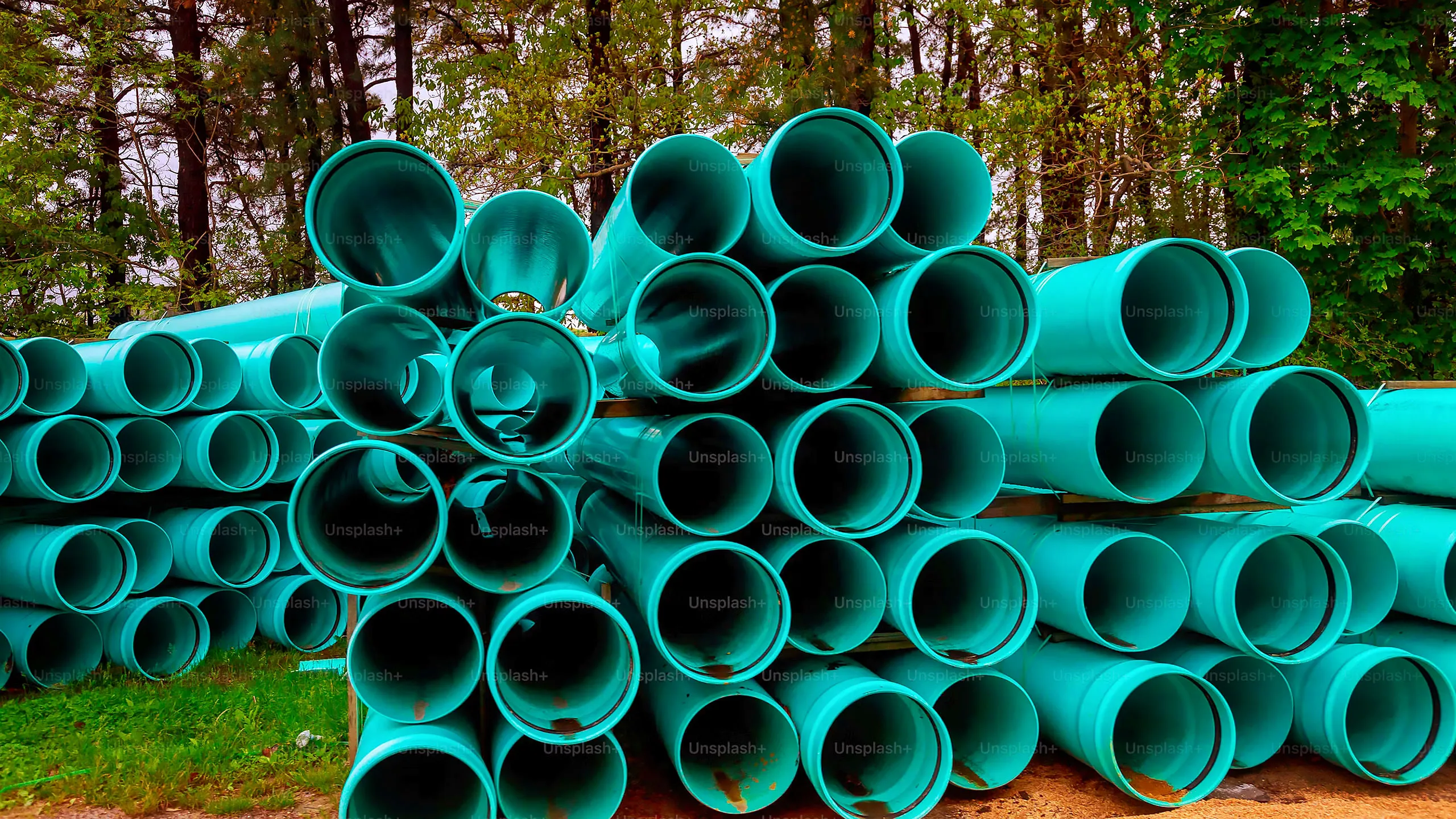 A stack of blue pipes with rust on them.