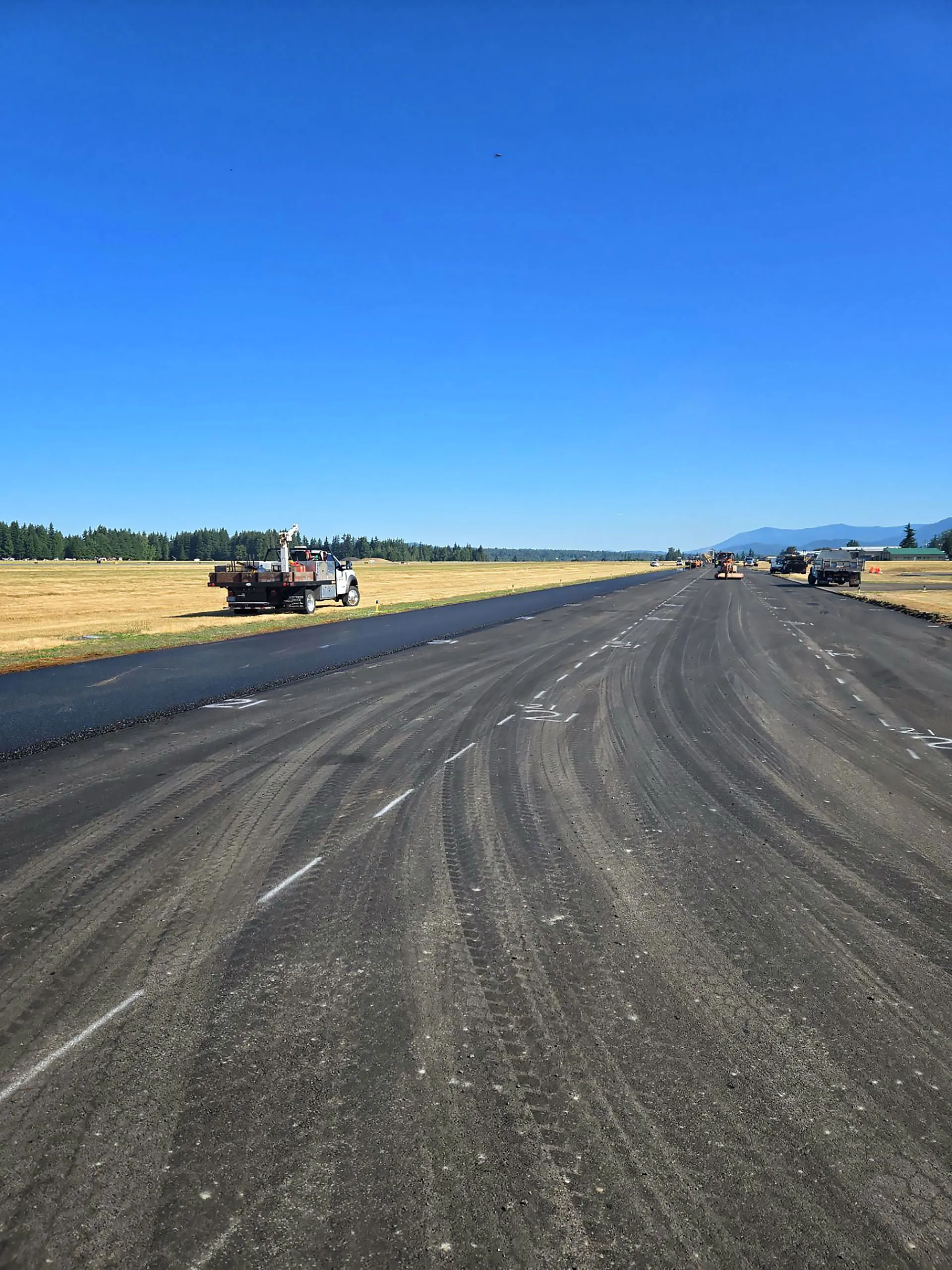A blacktop road with white lines.