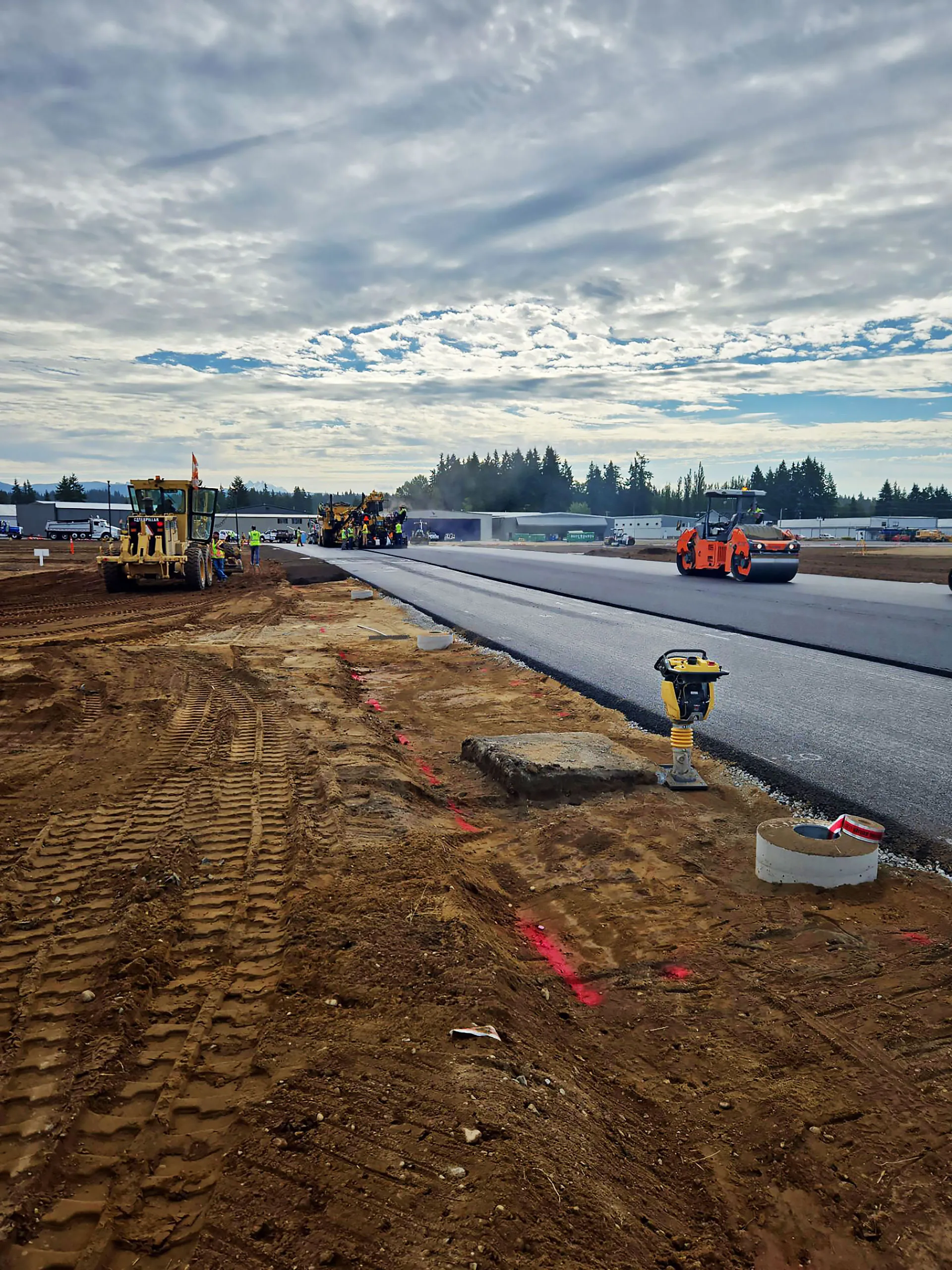 A road is being paved with a yellow machine.