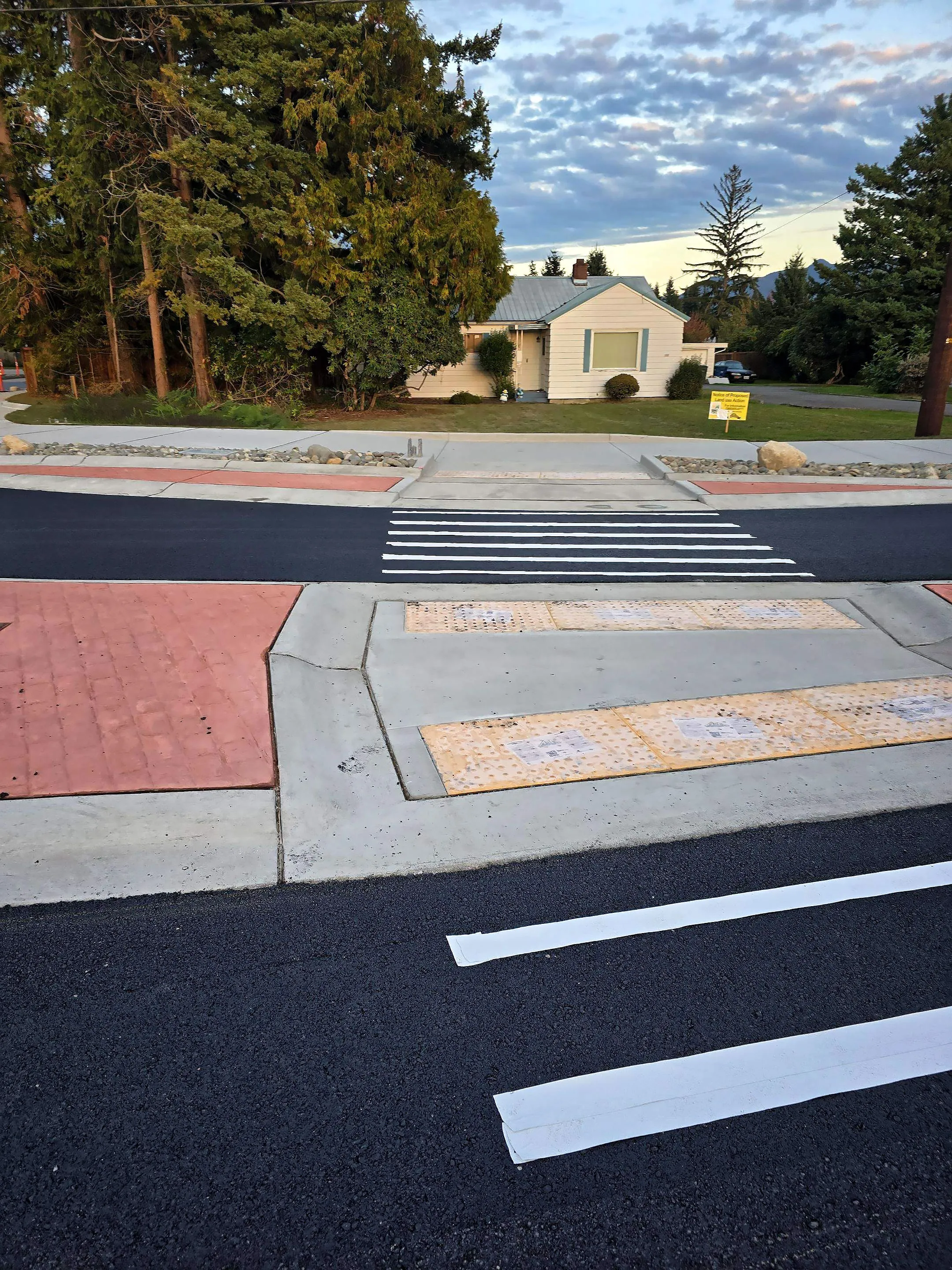 A crosswalk with a yellow and black striped design.