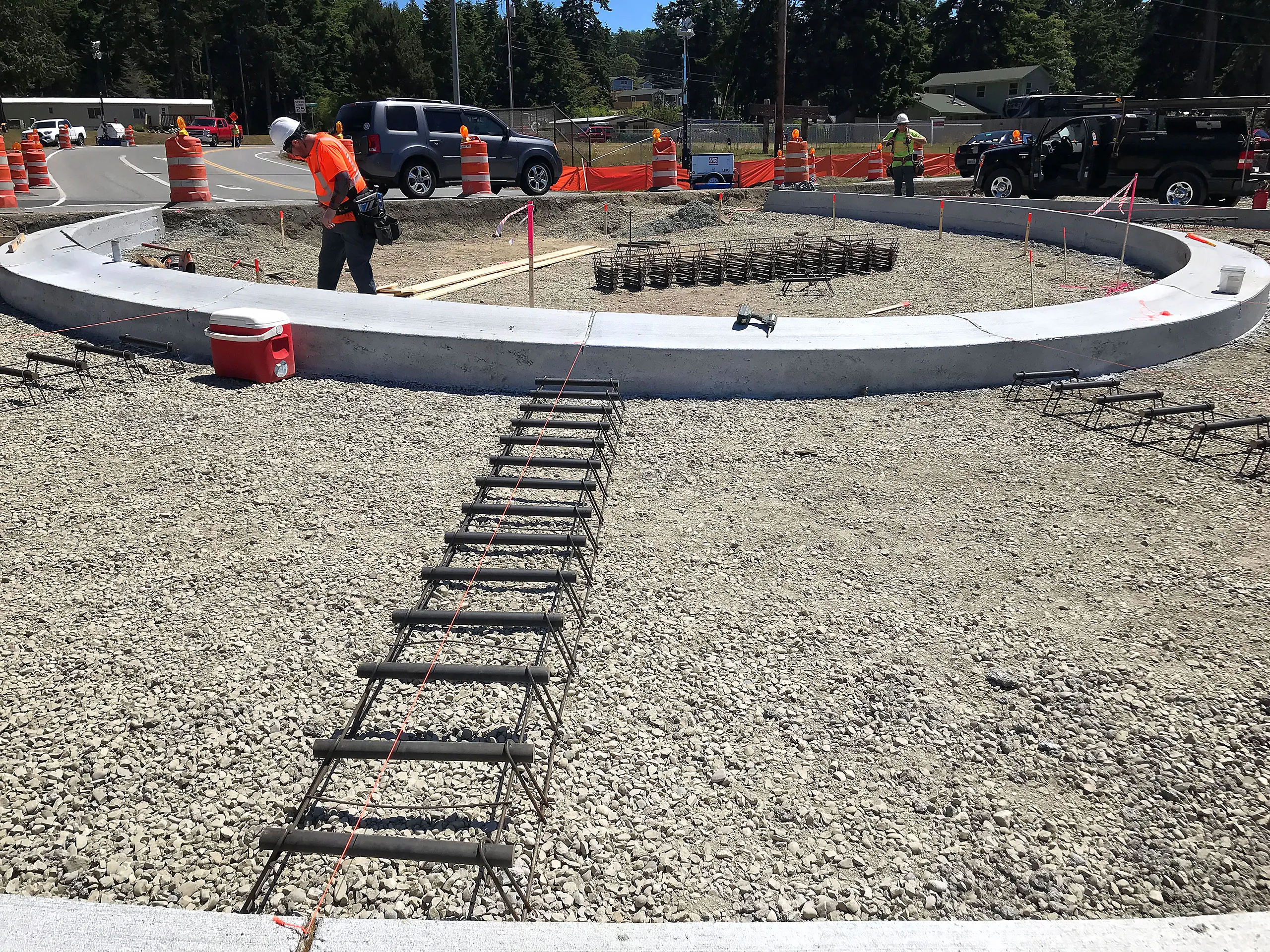 A construction site with a large cement circle and a metal ramp.