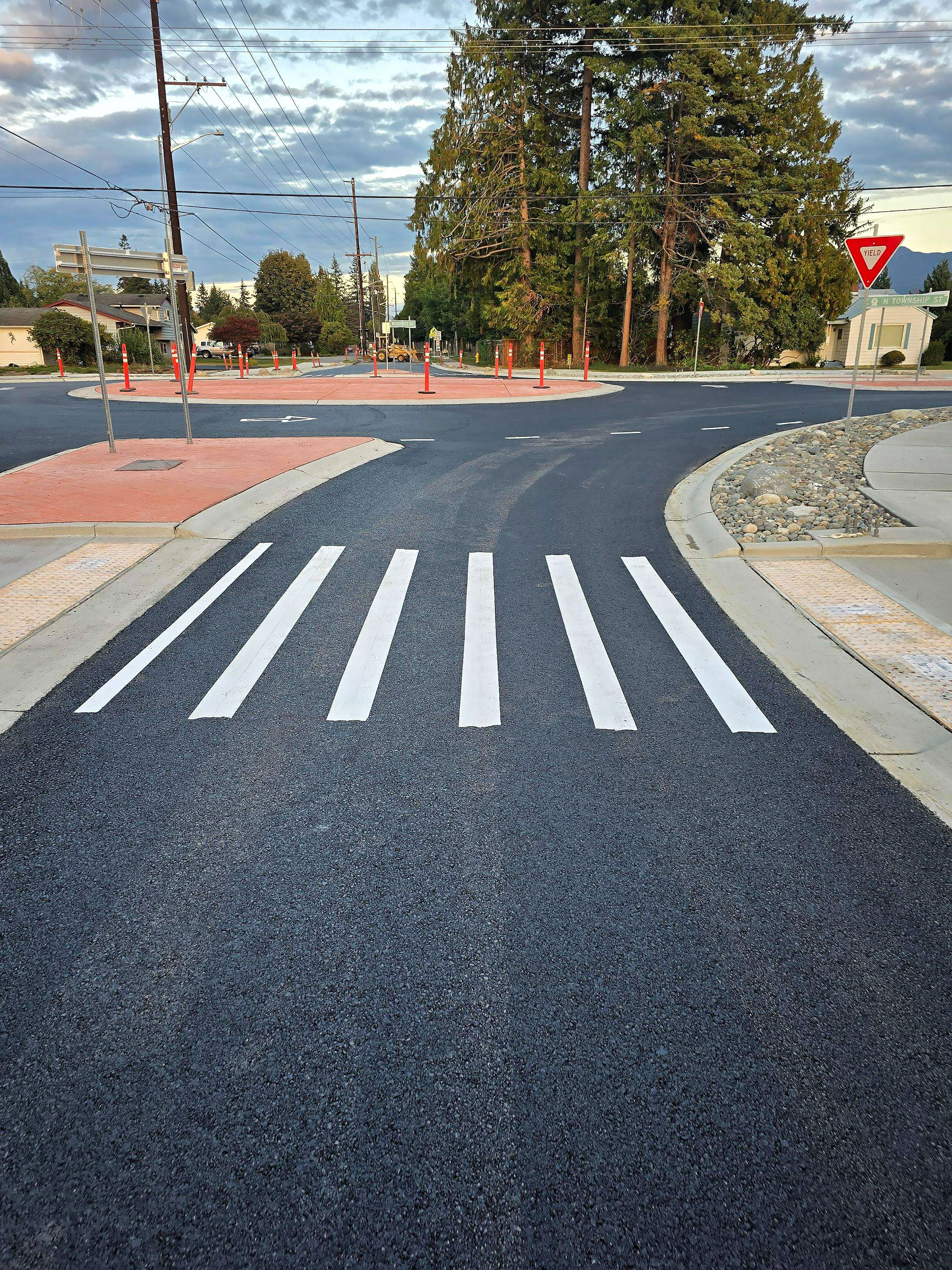 A black and white crosswalk with a red triangle on the side.