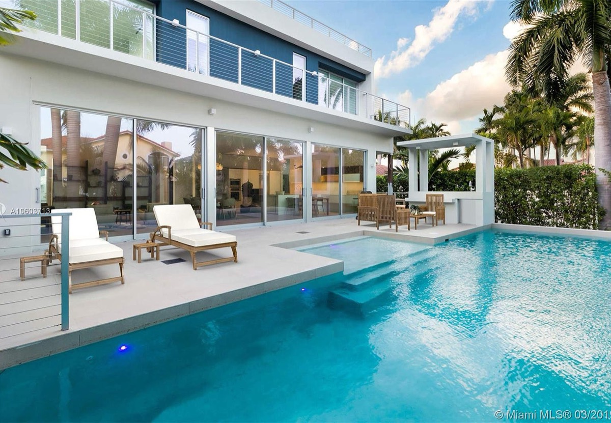 Caribbean home pool terrace with glass railings