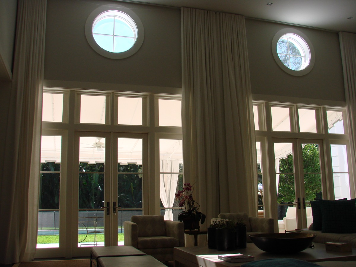 Bright traditional room with French doors and round transom window