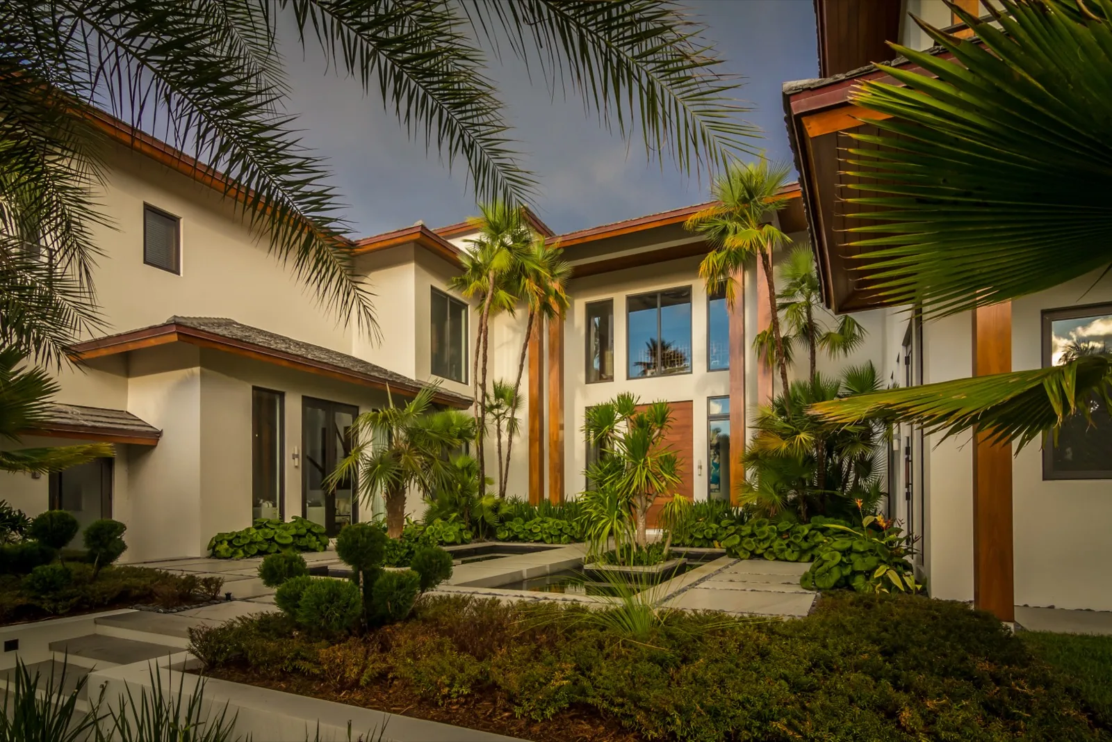 Bronze-framed two-story window bay on a modern facade
