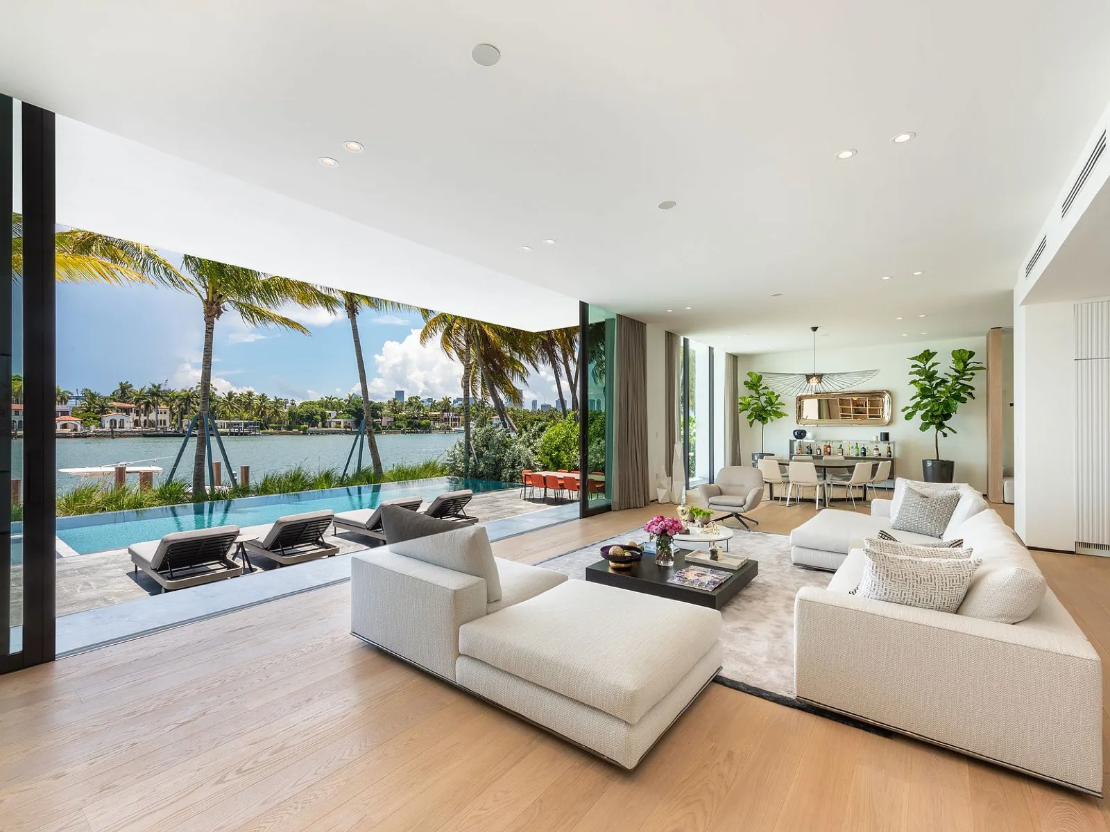 Folding glass wall fully retracted, living room open to pool