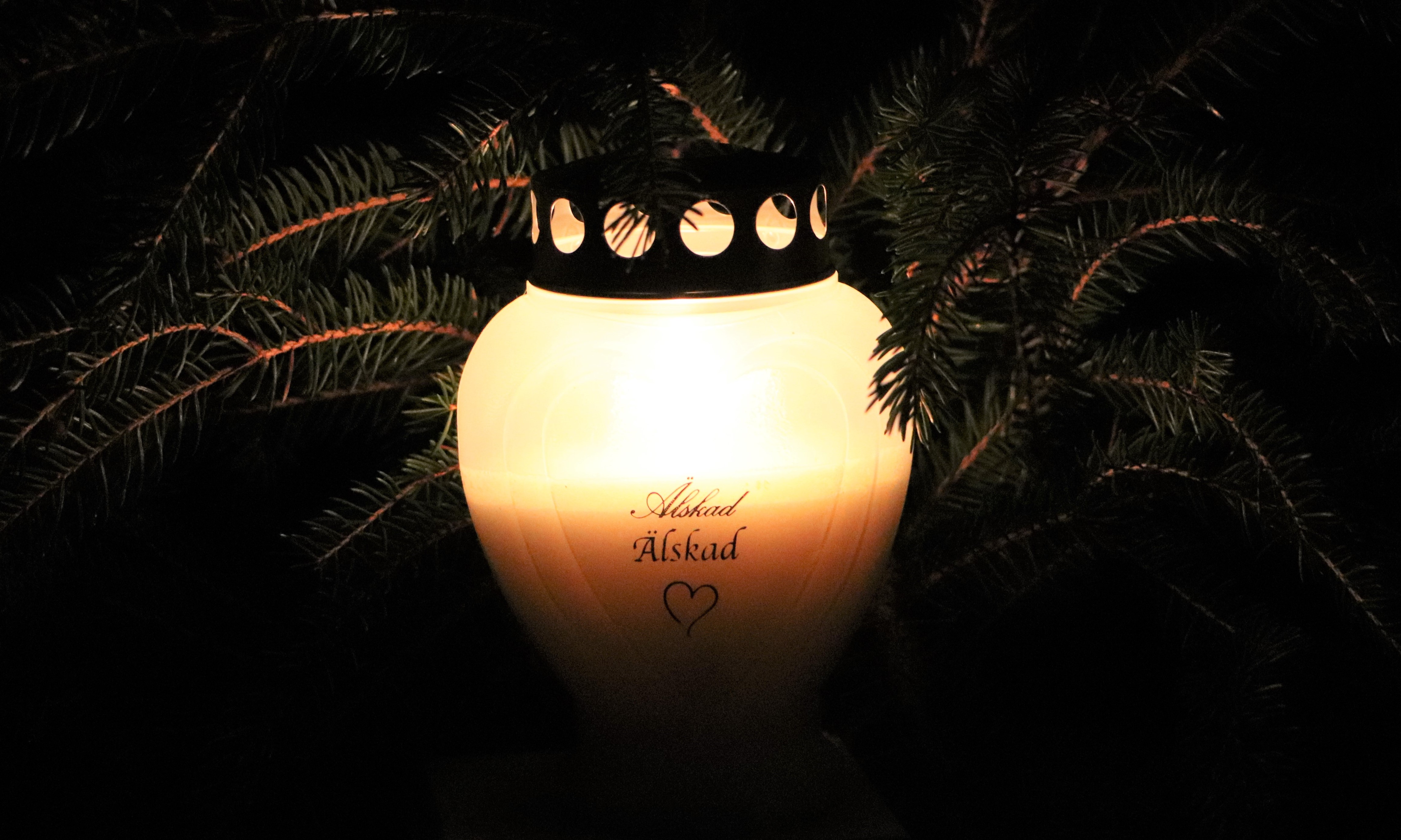 Memorial candles lit on graves for All Saints Day
