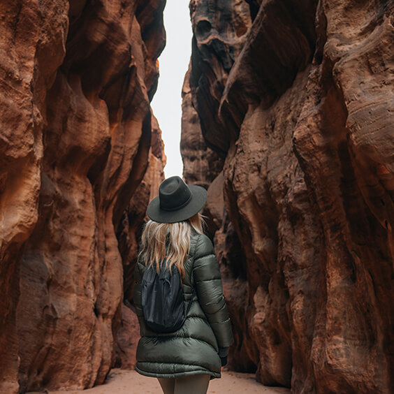 Traveler looking out over a dramatic canyon landscape at sunset, featured in the Instagram gallery.