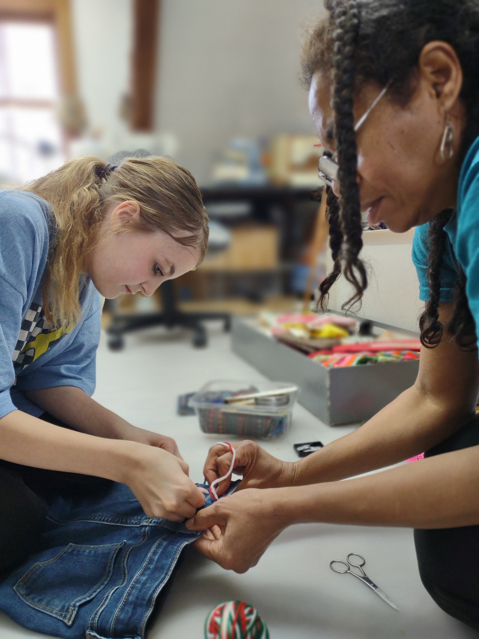 TMPUV mentor and mentee sewing clothes together