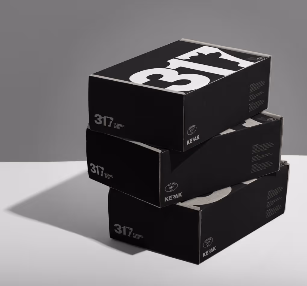 Stack of black and white boxes featuring the 317 logo repeated across the surfaces as a pattern.