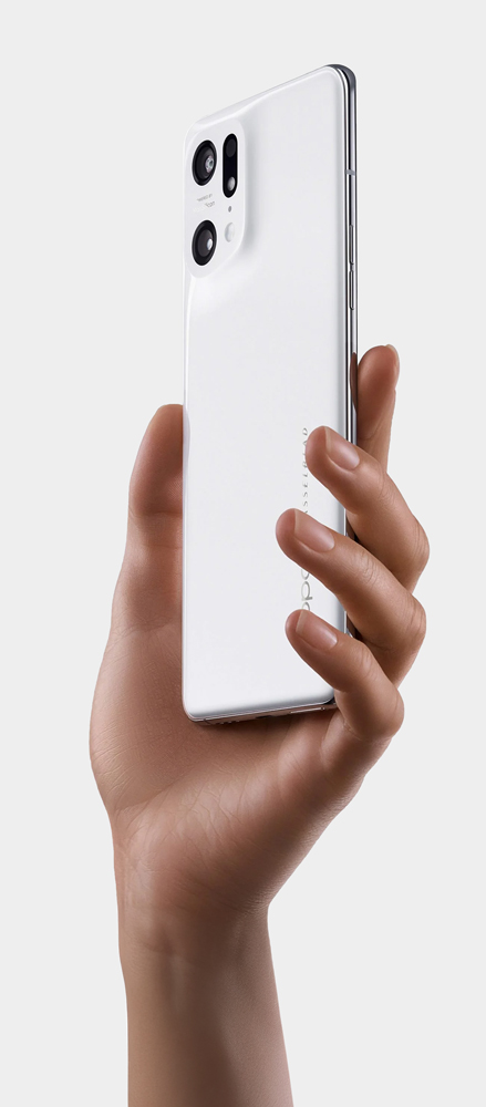 Hand holding a white smartphone with dual rear cameras and a slim profile against a white background.