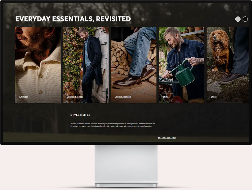Website screen showing a clothing collection titled 'Everyday Essentials, Revisited' with five images highlighting knitwear, jackets & coats, jeans & trousers, shirts, and shoes, featuring a man in outdoor settings with a dog and close-ups of the clothing and footwear. Below is a style note about heritage fabrics, seasonal textures, and rich tones inspired by the English countryside, with a link to shop the collection.