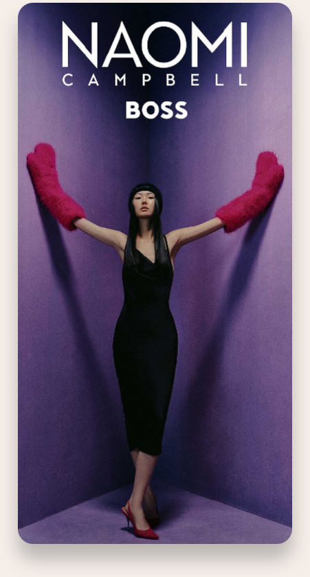 Naomi Campbell standing in a purple corner with arms outstretched wearing a black sleeveless dress, a black headband, bright pink fuzzy gloves, and red high heels, with the text 'NAOMI CAMPBELL BOSS' above her.