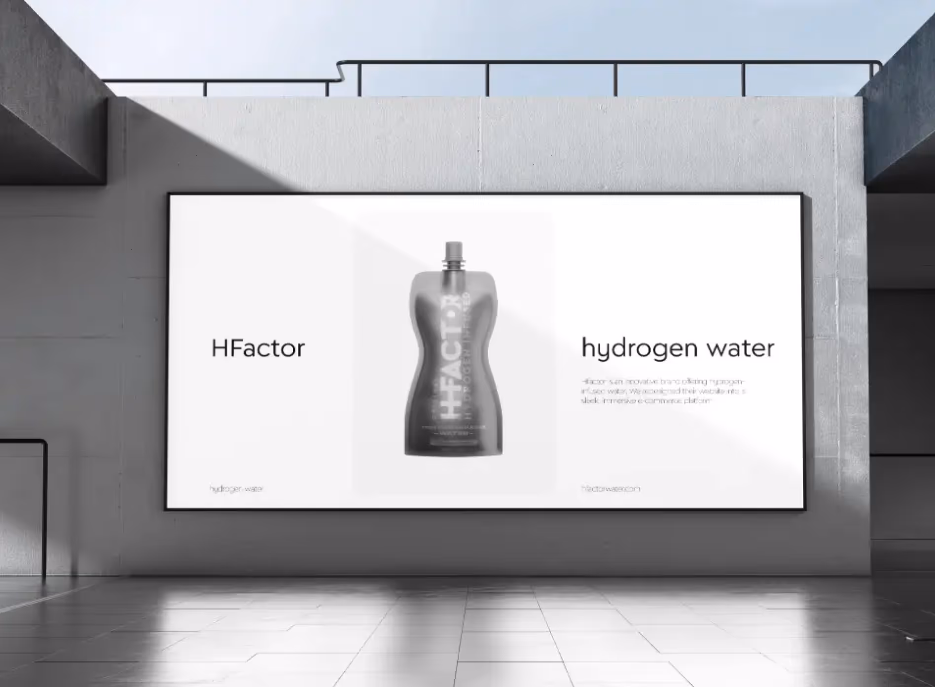 A large outdoor billboard displays a sleek, gray bottle of HFactor hydrogen water. The minimalist design is set against a modern, open sky background.