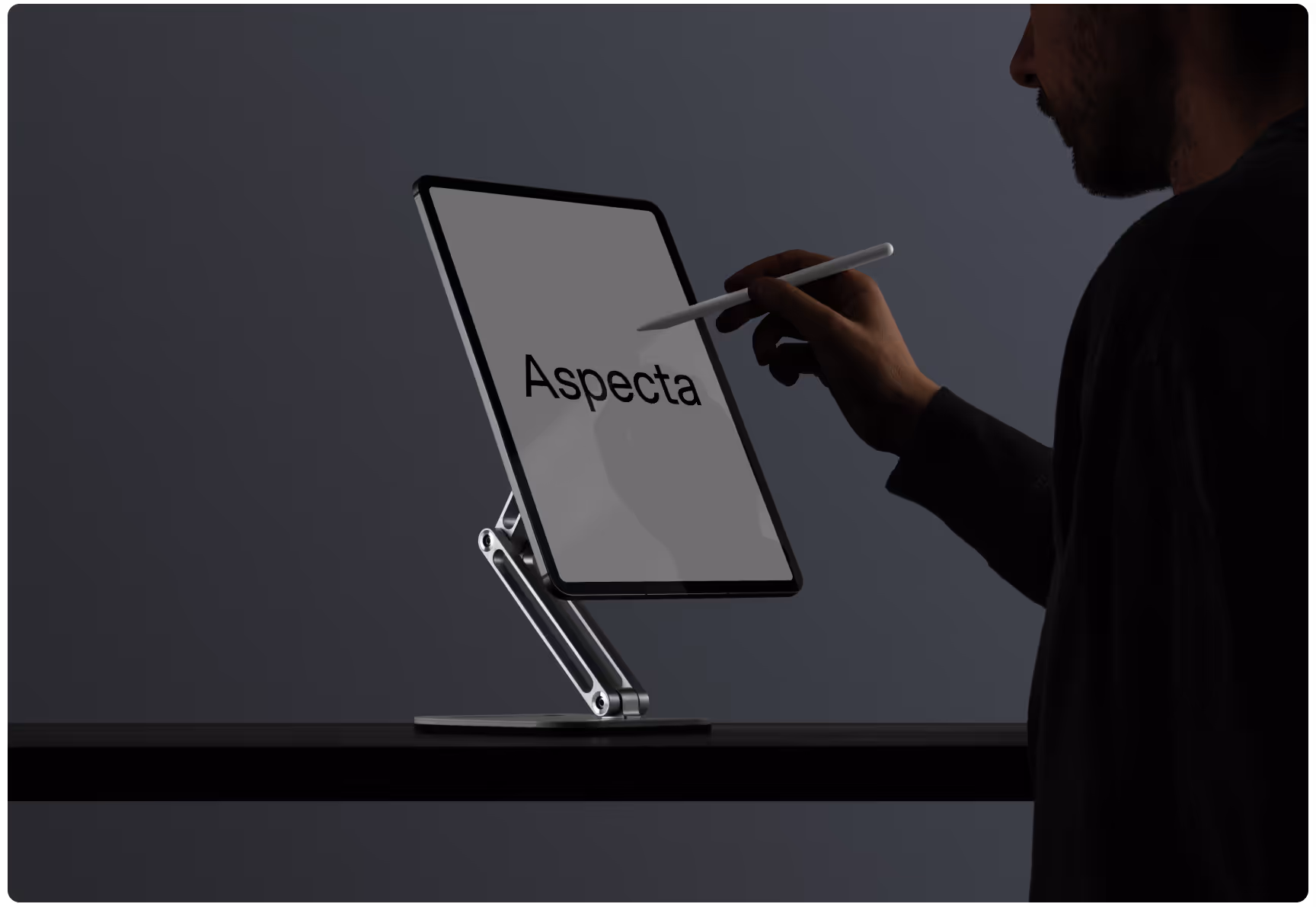 A person uses a stylus to write on a tablet mounted on a sleek metal stand in a dimly lit room. The word "Aspecta" is displayed on the screen.