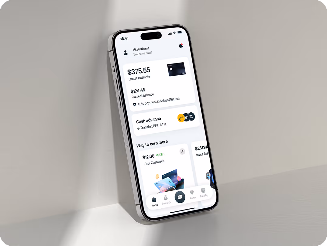 A smartphone screen displays a financial app with a balance of $375.55. The interface shows transactions, cash advance options, and earning methods. The phone is angled on a light-colored surface with soft lighting.