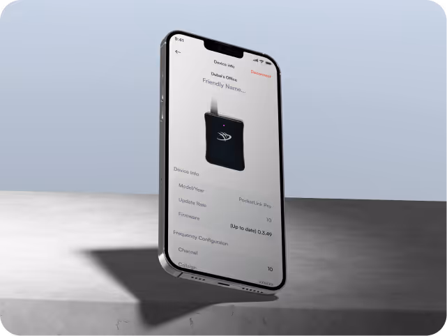 A smartphone is levitating above a gray concrete surface, displaying a device info screen with a black gadget icon. 