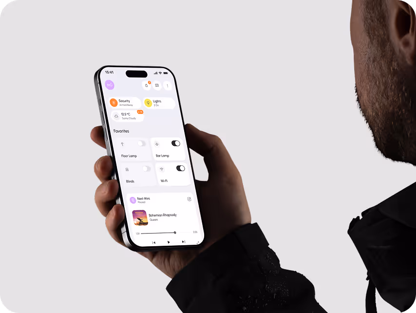 A person holds a smartphone displaying a sleek home automation app interface. The screen shows controls for security, lighting, and music, emitting a modern tech vibe.