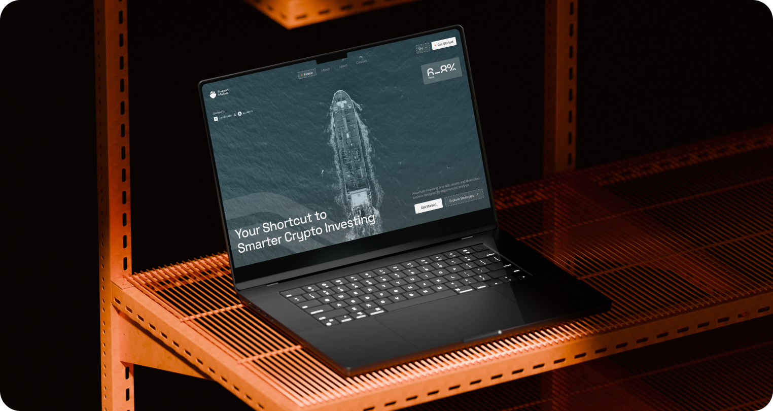 A black laptop on an orange metal shelf displays a website with a ship image and the text "Your Shortcut to Smarter Crypto Investing," conveying a modern, tech-savvy tone.