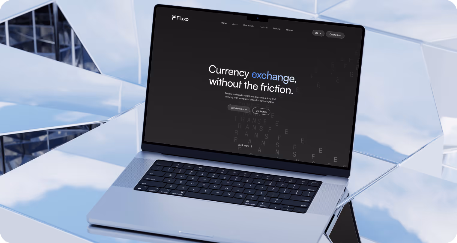 A sleek laptop displaying a website with the text "Currency exchange, without the friction" on a minimalist black background. Reflective tiles form a futuristic setting.