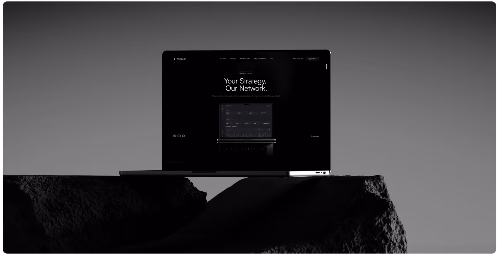 A sleek laptop displaying a dark-themed website with the text "Your Strategy, Our Network" on its screen, placed on textured rocks, in a monochrome setting.