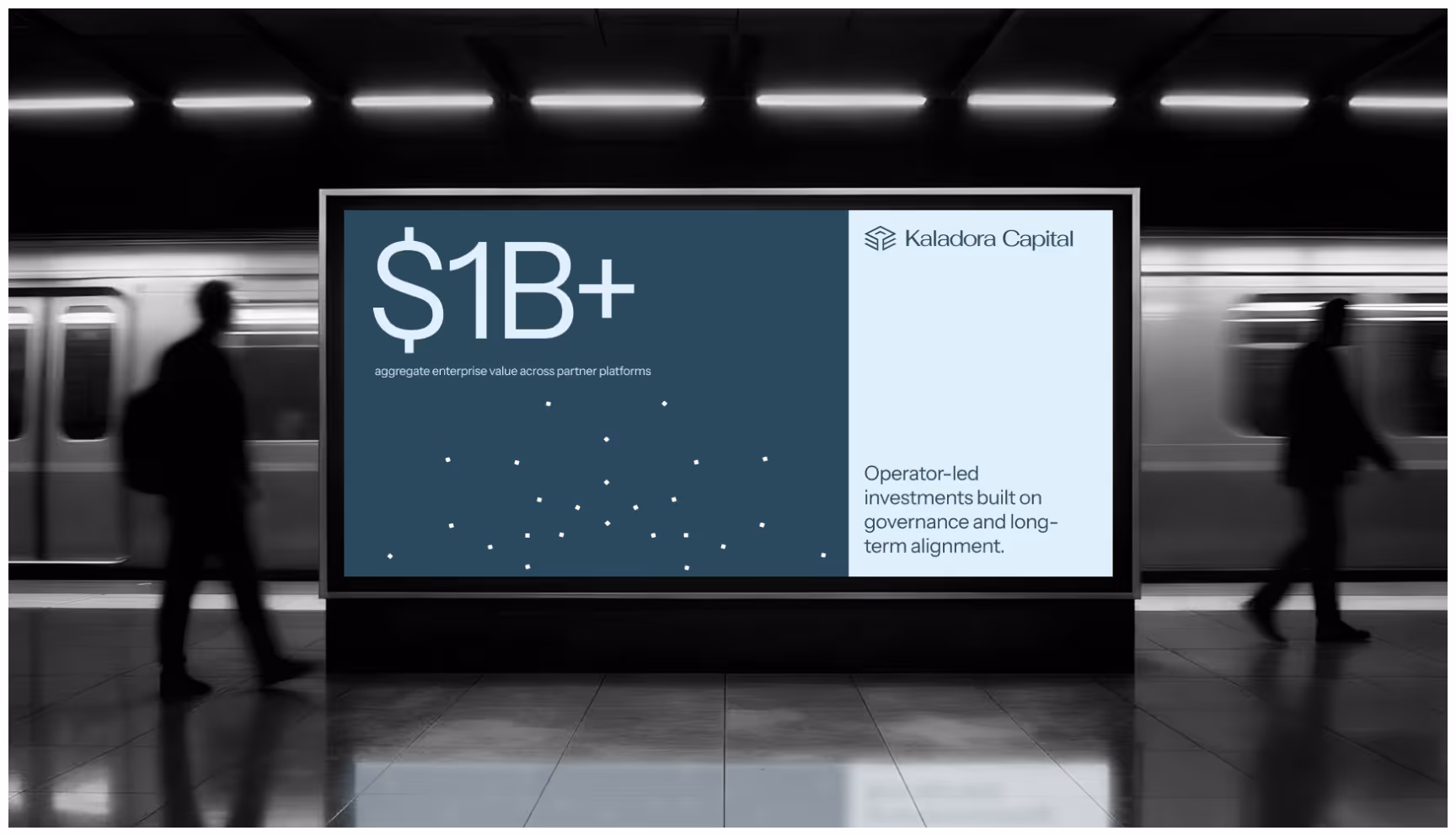 A subway platform features a prominent advertisement by Kaladora Capital. It displays "$1B+" with text about investments. Two people walk past, creating a dynamic city atmosphere.